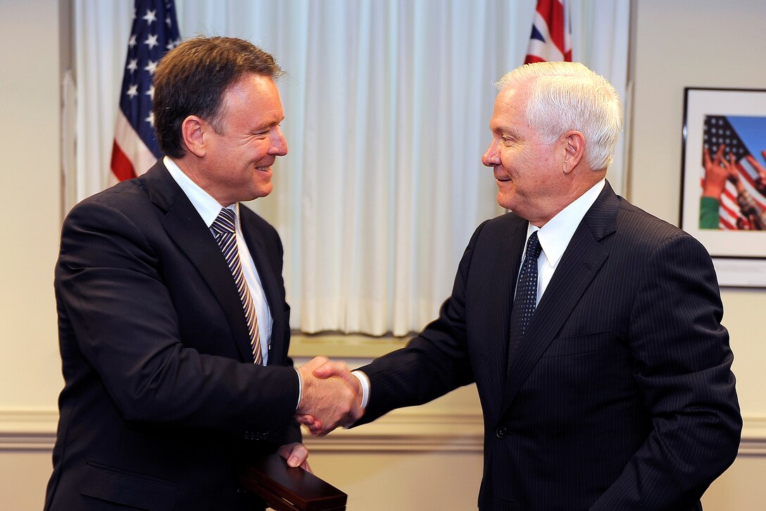 Australian Minister of Defense Joel Fitzgibbon, left, and U.S. Defense Secretary Robert M. Gates shake hands after signing a communications accord between Australia and the United States at the Pentagon, July 16, 2008.