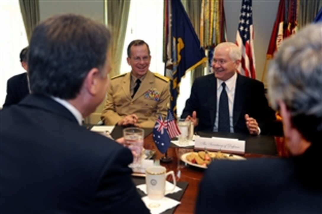 U.S. Navy Adm. Mike Mullen, chairman of the Joint Chiefs of Staff, left, and U.S. Defense Secretary Robert M. Gates, right, talk with Australian Minister of Defense Joel Fitzgibbon, near left, at the Pentagon, July 16, 2008. Fitzgibbon met with Defense Department officials and  signed a communications accord with Gates between Australia and the United States. 