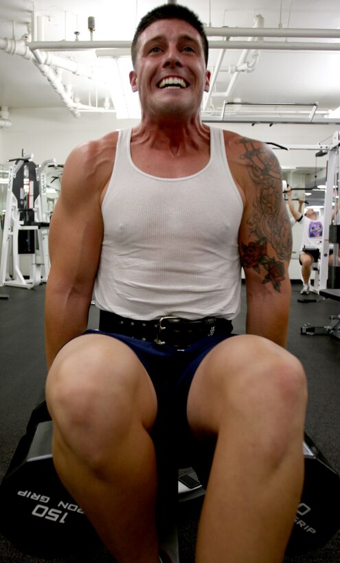 Sgt. Josh Hamra, G-4 maritime prepositioning force chief, U.S. Marine Corps Forces, Pacific, blasts his trapezius muscles while shrugging the new 150-pound dumbbells at the Semper Fit Center here.