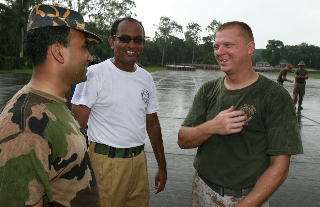 Staff Sgt. Michael Dase asks Bangladeshi service members how there day is going and if they enjoyed their training July 7 during Non-Lethal Weapons Executive Seminar 2008. Dase has dedicated his career to ensuring the morale of his Marines is just as important as mission accomplishment.