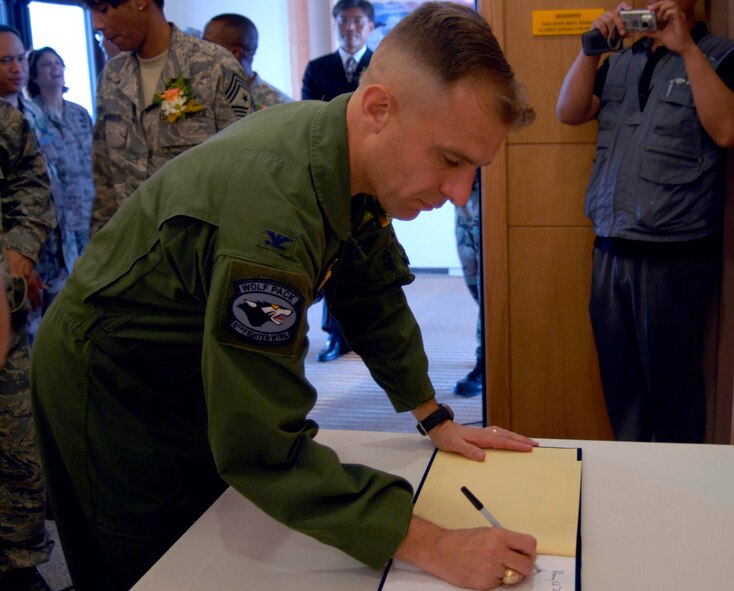 KUNSAN AIR BASE, Republic of Korea--Colonel Bryan "Wolf" Bearden, 8th Fighter Wing commander, signs the welcome book in the new dormitory here July 16. The ceremony dedicates the completion of the Wolf Pack's new FY06 tower dormitory. The project is part of the Air Force's initiative to improve the quality of life for Airmen. (U.S. Air Force photo by Senior Airman Dana Hill) 