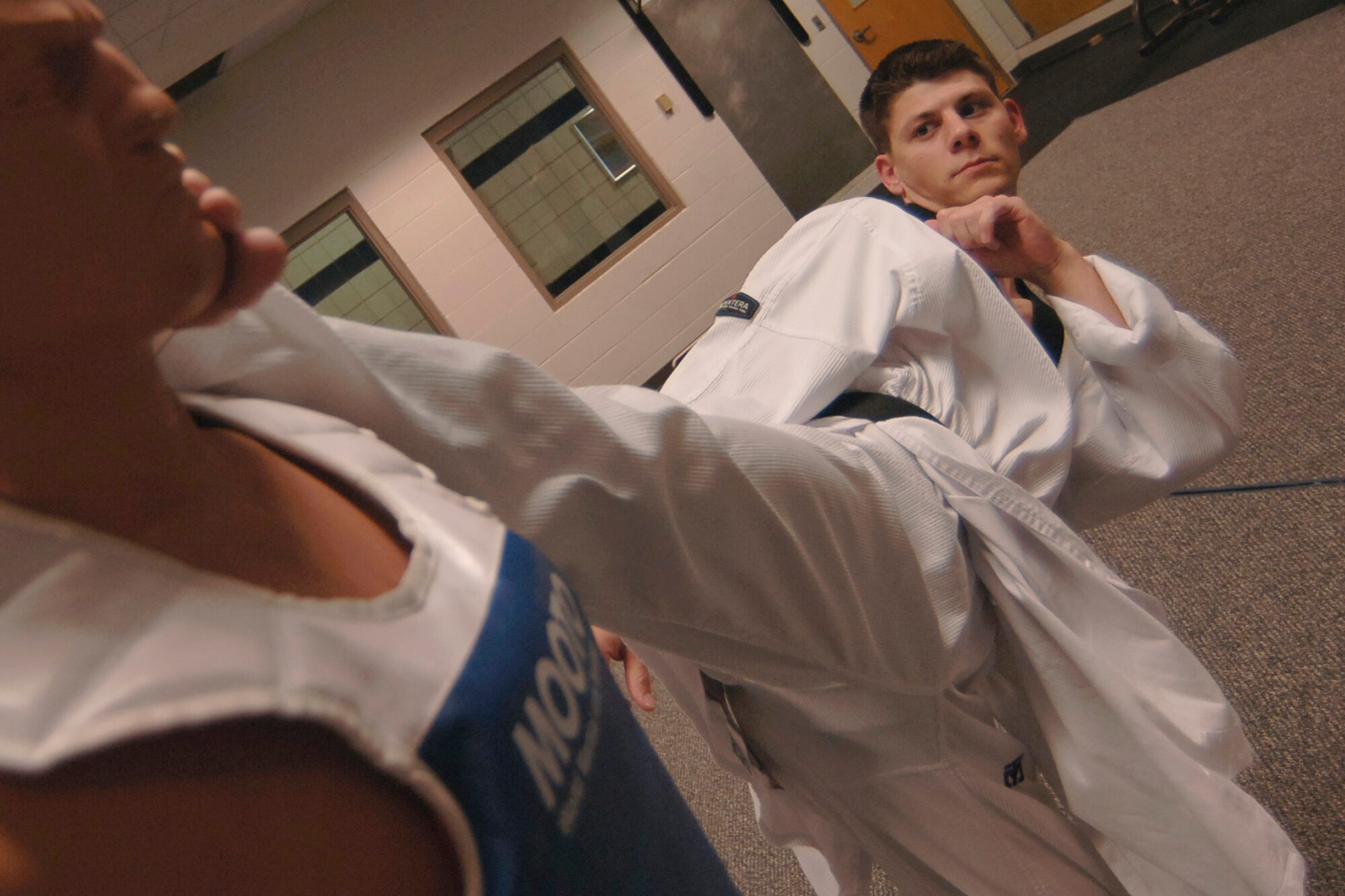 MCCONNELL AIR FORCE BASE, Kan. -- Airman 1st Class Jonathan Scherquist, 22nd Force Support Squadron, sidekicks a dummy component during a taekwondo training session, at the base fitness center, July 17. (Photo by Airman 1st Class Maria Ruiz)