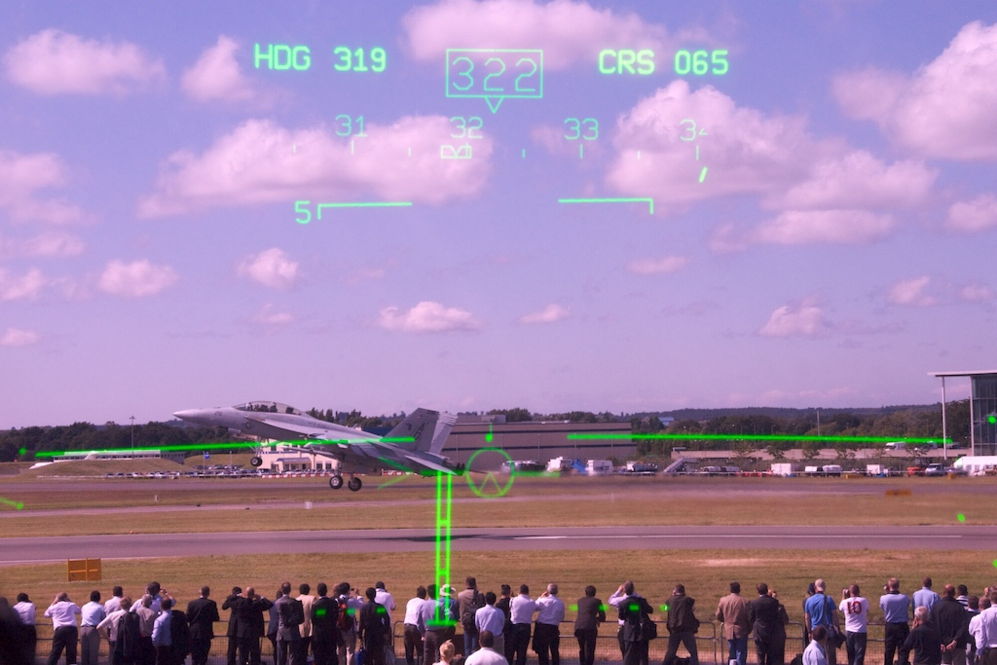The view from the Heads-Up Display of the Reserve 815th Airlift Squadron 'Flying Jennies' C-130J aircaft while a Navy F-18 Super Hornet takes off for a demonstration at the Farnborough Air Show.  The HUD is unique to the J-model and allows the pilot to see flight data constantly while looking out the windshield. The J-model is the only C-130 in the world with a HUD.