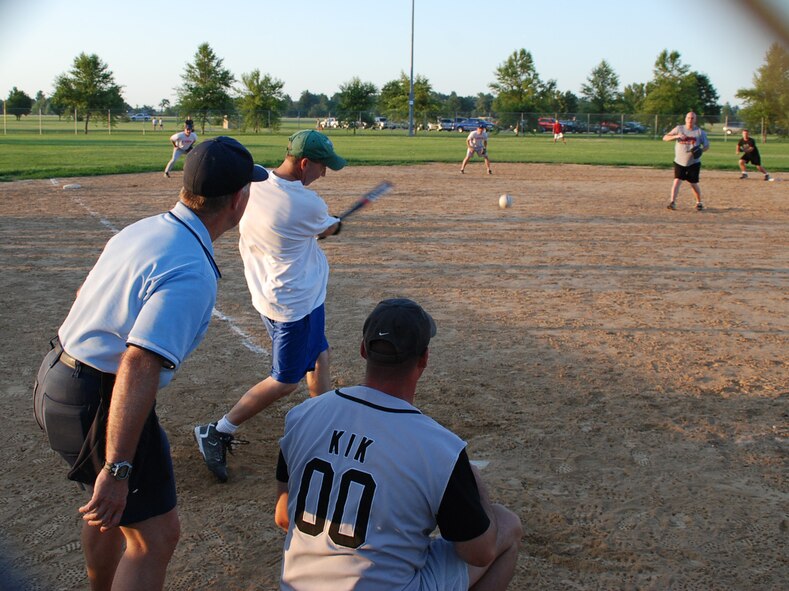The 932nd Airlift Wing, Maintenance Group's Senior Master Sgt. Michael Rak ,swings hard and connects on a base hit during the competitive softball game featuring the wing versusus the security forces.  The "forces" won rather heavily in the end but the event brought out great warrior spirit and friendship in all who played.  Photo/Maj. Stan Paregien