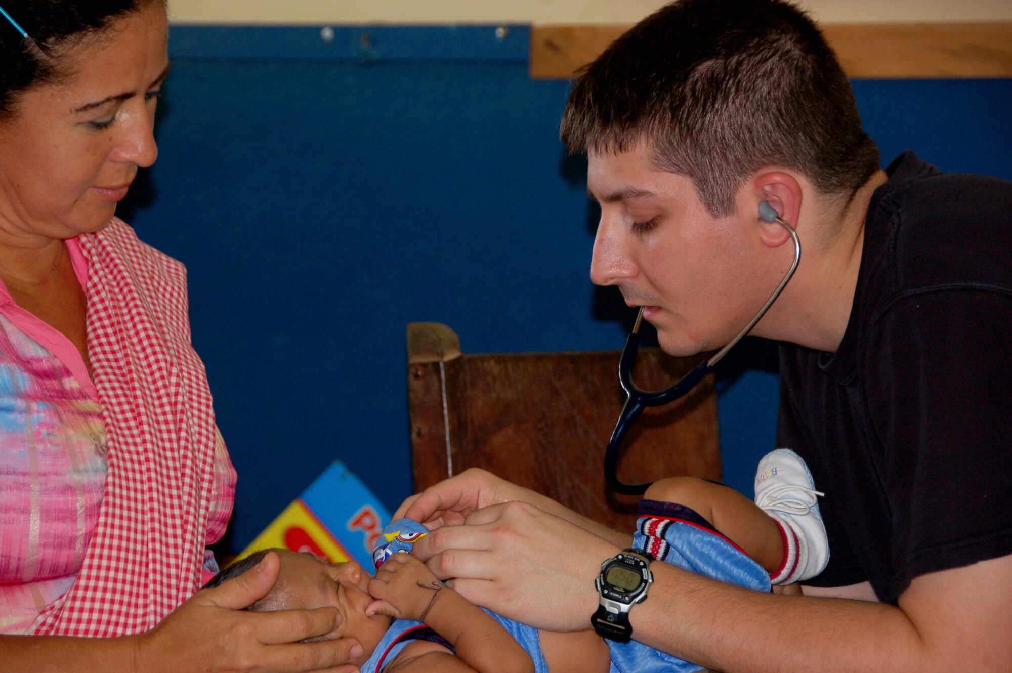DSC_7642: Capt Kermit G. Helo, a pediatrician from the 81st Medical Operations Squadron at Keesler Air Force Base, Miss., deployed to Medical Readiness Training Exercise (MEDRETE) Panama checks the heartbeat of an infant here at the Escuela de Cabuya school in Cabuya, Panama 16 July. The MEDRETE is a two-week long U.S. Southern Command-sponsored and AFSOUTH-coordinated exercise designed to hone the skills of medical personnel while providing free health care in remote locations through partnership with host nation doctors. Approximately 1,700 patients were seen by the medical staff at the Cabuya location 14-16 July. (Photo by Capt. Ben Sakrisson, Air University Public Affairs)