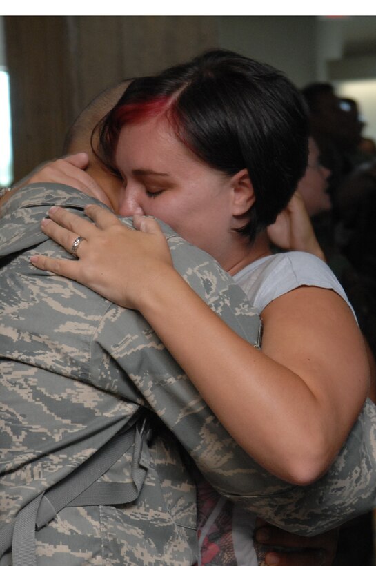 Airman 1st Class Nicholas Wengerd, 28th Civil Engineer Squadron electrical systems apprentice, returns home from a six-month deployment to Balad Air Base, and is welcomed by his wife, Jackie Wengerd, at Rapid City Regional Airport in Rapid City, S.D., July 17. While serving at Balad,members of the 28 CES provided rapid, decisive and sustainable mission support by maintaining the air field and improving the quality of life for service members. (US Air Force Photo/Airman 1st Class Adam Grant)  