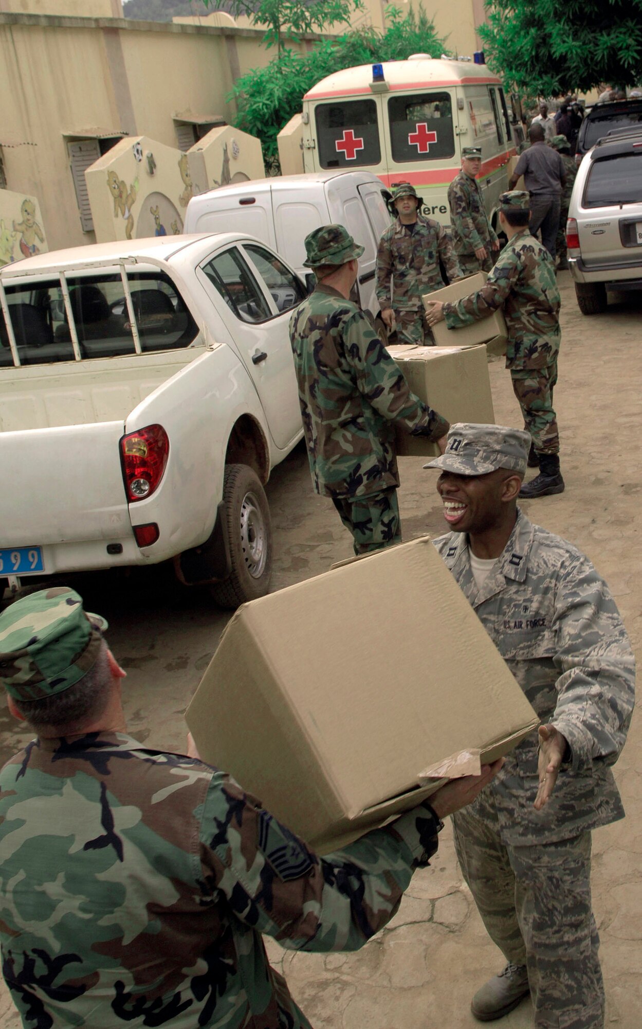 Airmen from the 31st Medical Group at Aviano Air Base, Italy, pass boxes of children's clothing to be donated to the Bamako National Orphanage, July 16.  Aviano Airmen collected more than 2,500 pounds of clothing, toys and shoes to distribute at Bamako orphanages. (U.S. Air Force photo/Senior Airman Michael S. Dorus)