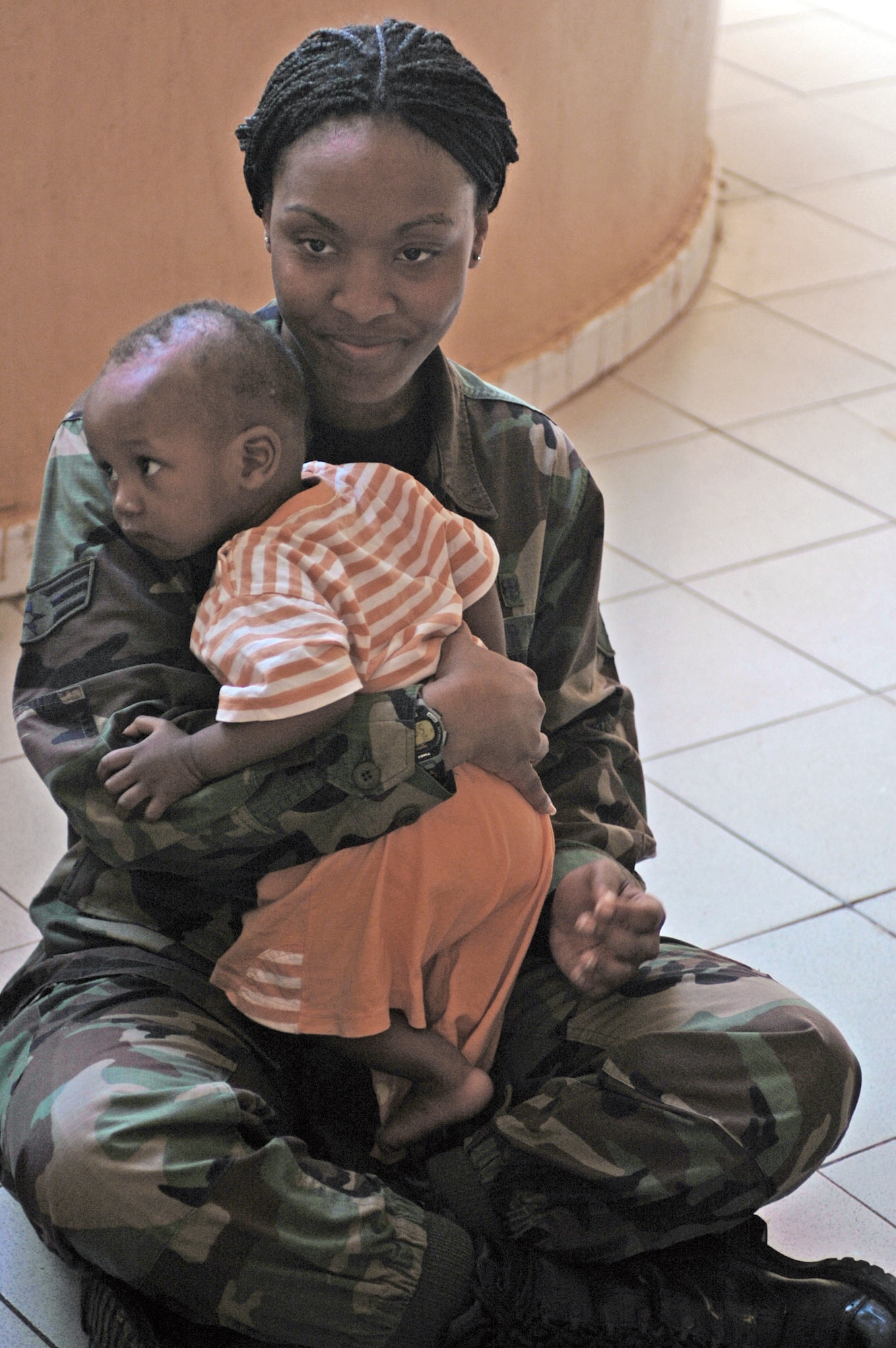 Senior Airman Latrisha Peebles holds a Malian baby July 16 at a local orphanage in Bamako. Airman Peebles is one of more than 90 servicemembers deployed to Bamako for MEDFLAG 08, a multi-national medical training exercise designed to enhance medical capabilities and readiness for U.S. and African forces. She is assigned to the 31st Medical Group, Aviano Air Base, Italy. (U.S. Air Force photo/Senior Airman Justin Weaver)