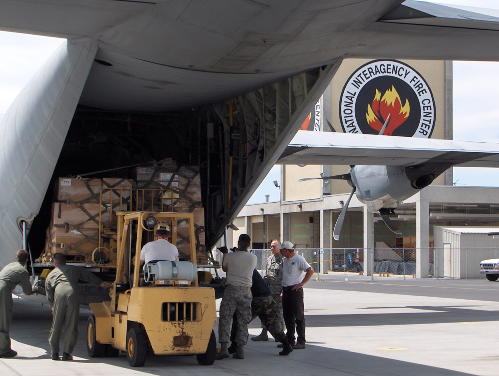 Members of the 146th Aerial Port Squadron of the California Air National Guard load a pallet of boots from the National Interagency Fire Center onto a C-130 aircraft from the 146th Airlift Wing before they are sent to National Guard troops fighting wildfires in California July 5. The 146th AW is conducting firefighting support missions as part of the 302nd Air Expeditionary Group. The 302nd AEG, comprised of aircraft from the Air Force Reserve, Air National Guard, Navy and Marine Corps, provides unique capabilities and is part of a unified military support effort of U.S. Northern Command to provide assistance to the U.S. Forest Service, the California Department of Forestry and Fire Protection, and the National Interagency Fire Center. USNORTHCOM continues to closely monitor the California wildfires to anticipate additional requests for Department of Defense assistance to local, federal, and state civil authorities. Photo by Patti Bielling