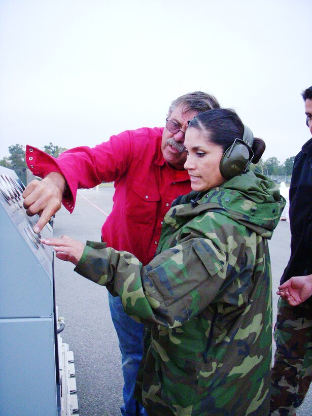 Staff Sgt. Sylvia Garcia and Paul Wivert, Modular Airborne Firefighting Systems mechanic with the 146th Aerial Port Squadron control the compressor to push air through a loading hose to force the fire retardant through and into the MAFFS on a C-130 aircraft supporting the 302nd MAFFS retardant reload operations at Channel Islands Air National Guard Station. The 302nd AEG, comprising aircraft from the Air Force Reserve, Air National Guard, Navy and Marine Corps, provides unique capabilities and is part of a unified military support effort of U.S. Northern Command to provide assistance to the U.S. Forest Service, CAL FIRE, and the National Interagency Fire Center. USNORTHCOM continues to closely monitor the California wildfires to anticipate additional requests for Department of Defense assistance to local, federal, and state civil authorities. Photo by Capt. Lisa Citino