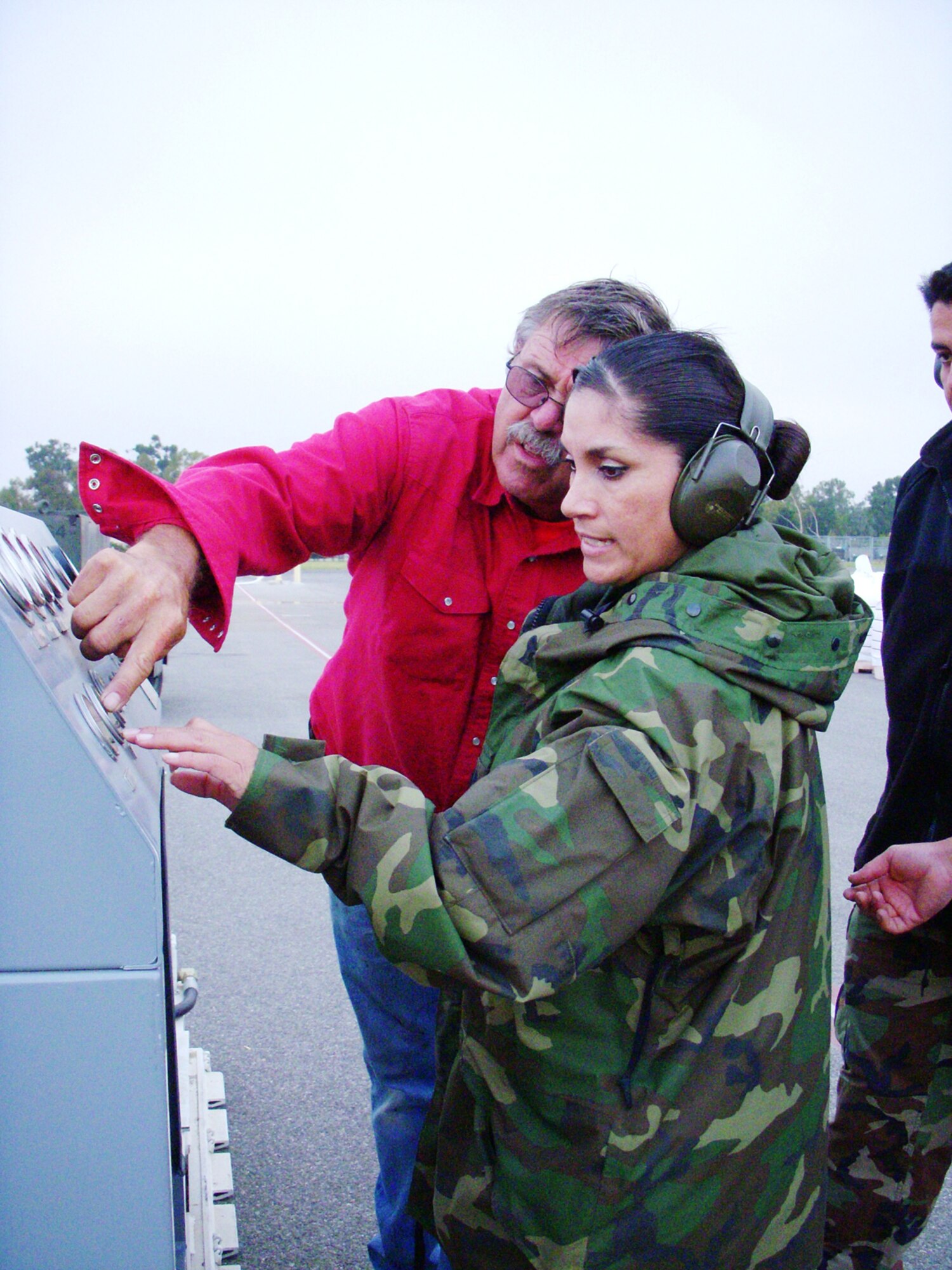 Staff Sgt. Sylvia Garcia and Paul Wivert, Modular Airborne Firefighting Systems mechanic with the 146th Aerial Port Squadron control the compressor to push air through a loading hose to force the fire retardant through and into the MAFFS on a C-130 aircraft supporting the 302nd MAFFS retardant reload operations at Channel Islands Air National Guard Station. The 302nd AEG, comprising aircraft from the Air Force Reserve, Air National Guard, Navy and Marine Corps, provides unique capabilities and is part of a unified military support effort of U.S. Northern Command to provide assistance to the U.S. Forest Service, CAL FIRE, and the National Interagency Fire Center. USNORTHCOM continues to closely monitor the California wildfires to anticipate additional requests for Department of Defense assistance to local, federal, and state civil authorities. Photo by Capt. Lisa Citino