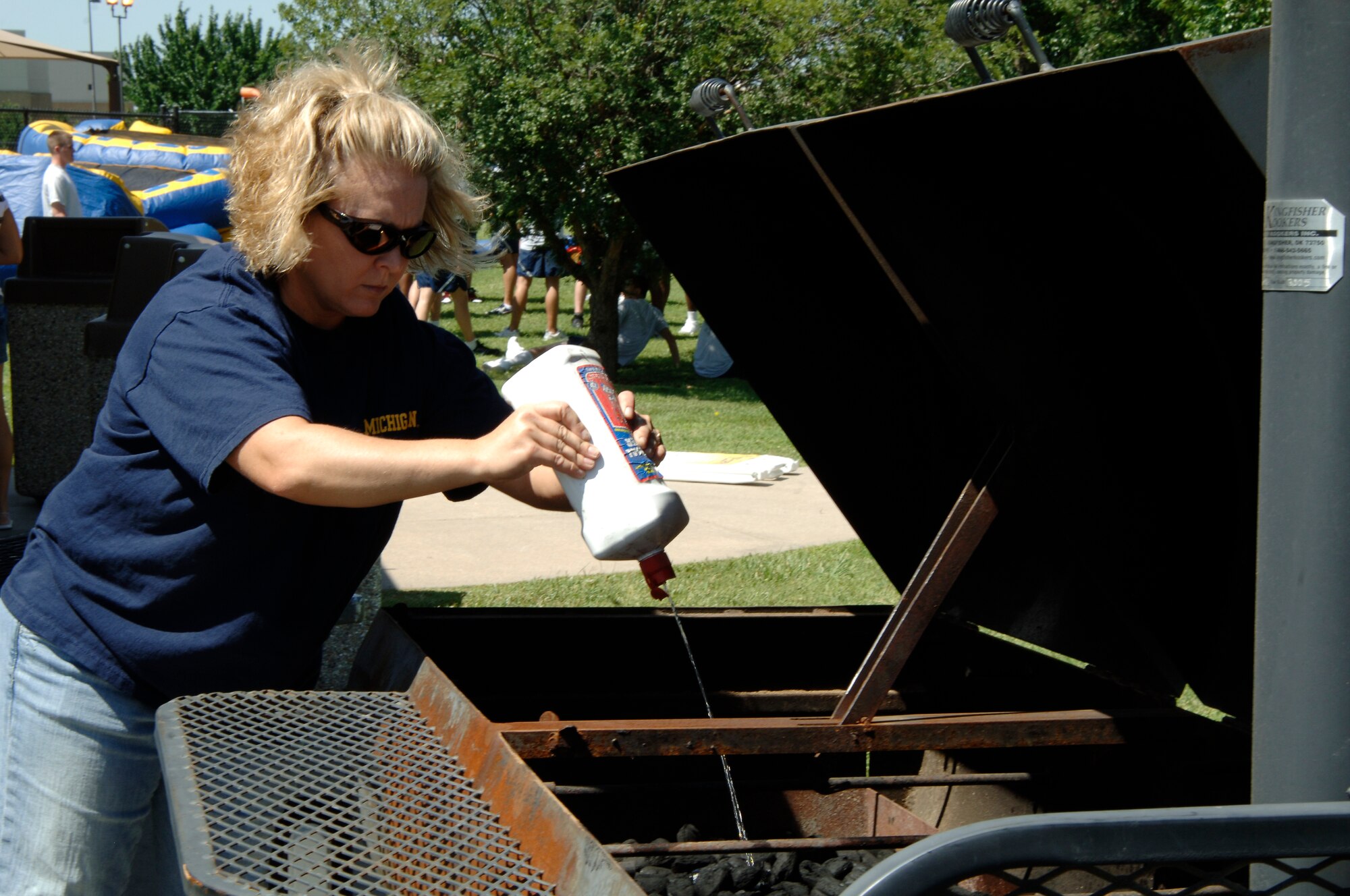 MCCONNELL AIR FORCE BASE, Kan. – Tech. Sgt. Rachel Bias, 22nd Force Support Squadron, prepares the grill for the 22nd FSS picnic, here, July 11. (Photo by Senior Airman Laura Suttles)