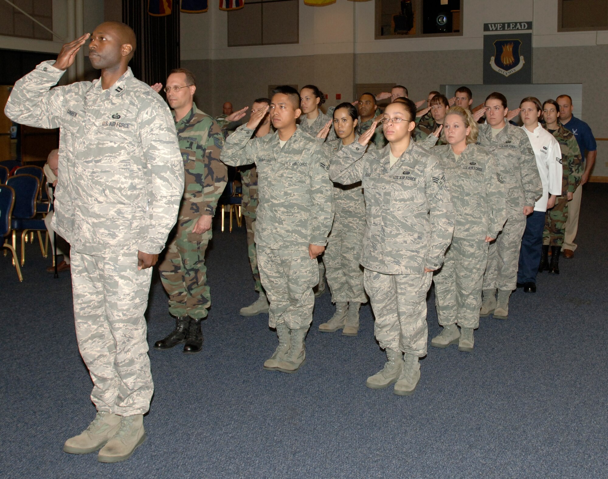 MCCONNELL AIR FORCE BASE, Kan. – Captain Willie Copper, 22nd Force Support Squadron deputy commander, leads a salute to newly appointed 22nd Force Support Squadron commander, Lt. Col. Sonya Collins, at the Robert J. Dole Center ballroom, July 11. (Photo by Staff Sergeant Jamie Train)