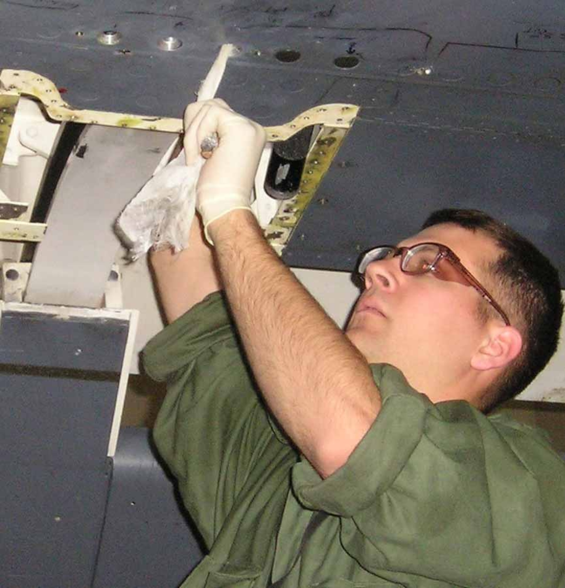 Tech. Sgt. Hill works on a B-1 flap while on temporary duty.  (Courtesy photo)