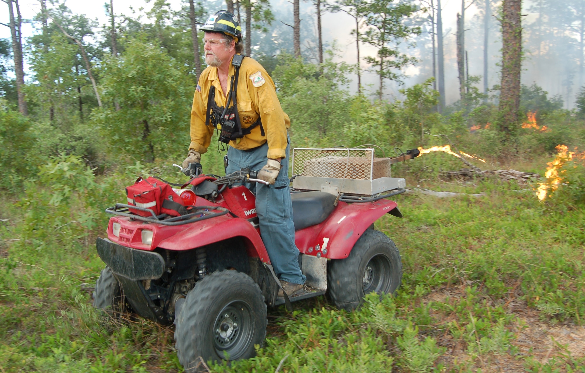 EGLIN AIR FORCE BASE, Fla. -- Roger Kennedy, Eglin fire management specialist, sets a prescribed fire using his all-terrain vehicle on the Eglin reservation.  (U.S. Air Force photo by Jerron Barnett)