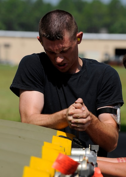 MOODY AIR FORCE BASE, Ga. -- Senior Airman Derrick Kenning, 23rd Equipment Maintenance Squadron, helps build a live MK-82 bomb here July 17. The MK-82 is a 500 lb. general purpose bomb that was used on an A-10C Thunderbolt II  training flight the following week. (U.S. Air Force photo by Senior Airman Brittany Barker) 