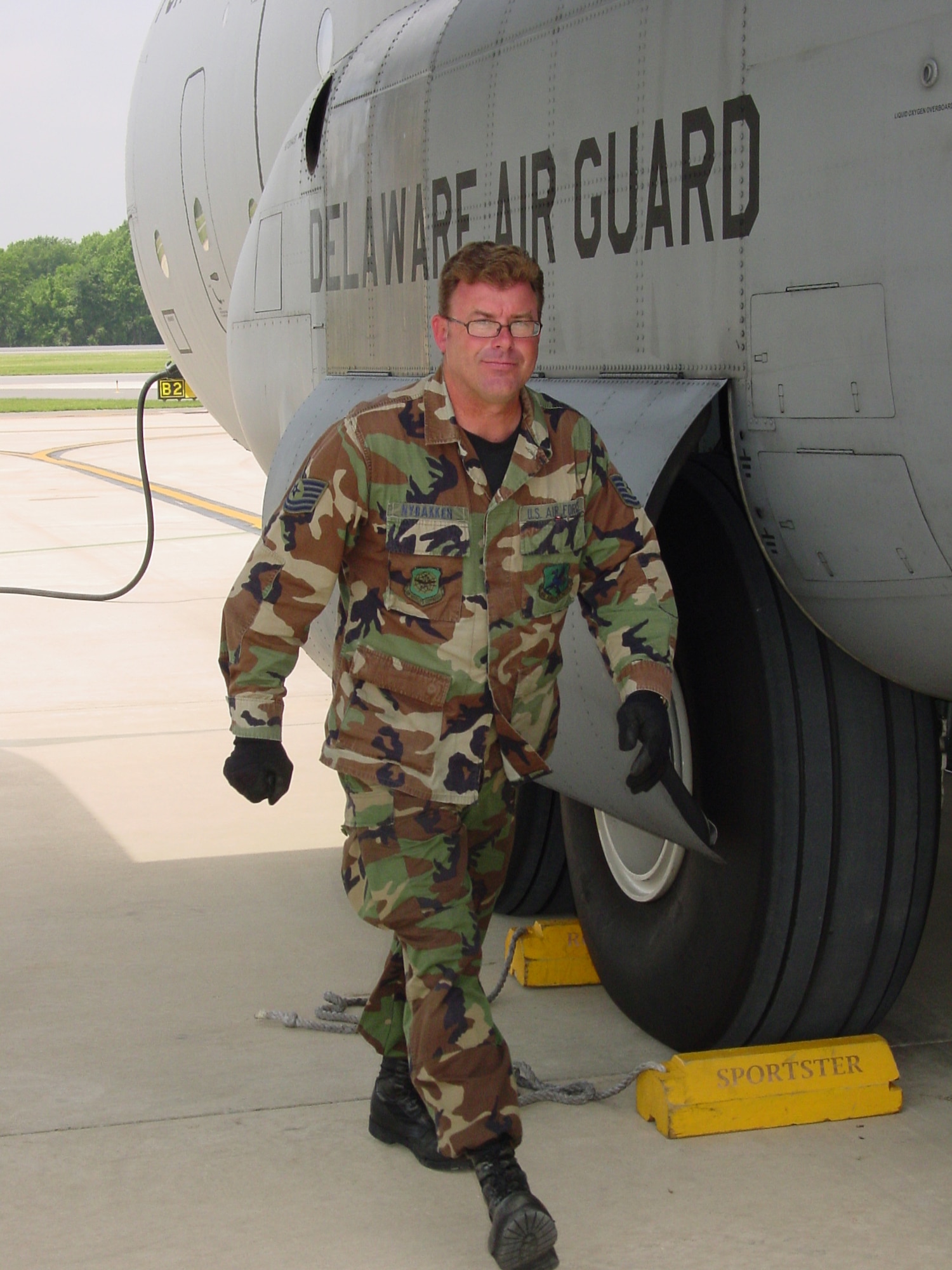Technical Sgt. Scott Nybakken, crew chief for C-130 aircraft #213, Delaware Air National Guard, continues on to another post-flight task after the aircraft became the first in the unit's C-130H fleet to reach the 10,000 hour flying milestone on June 5, 2008.   