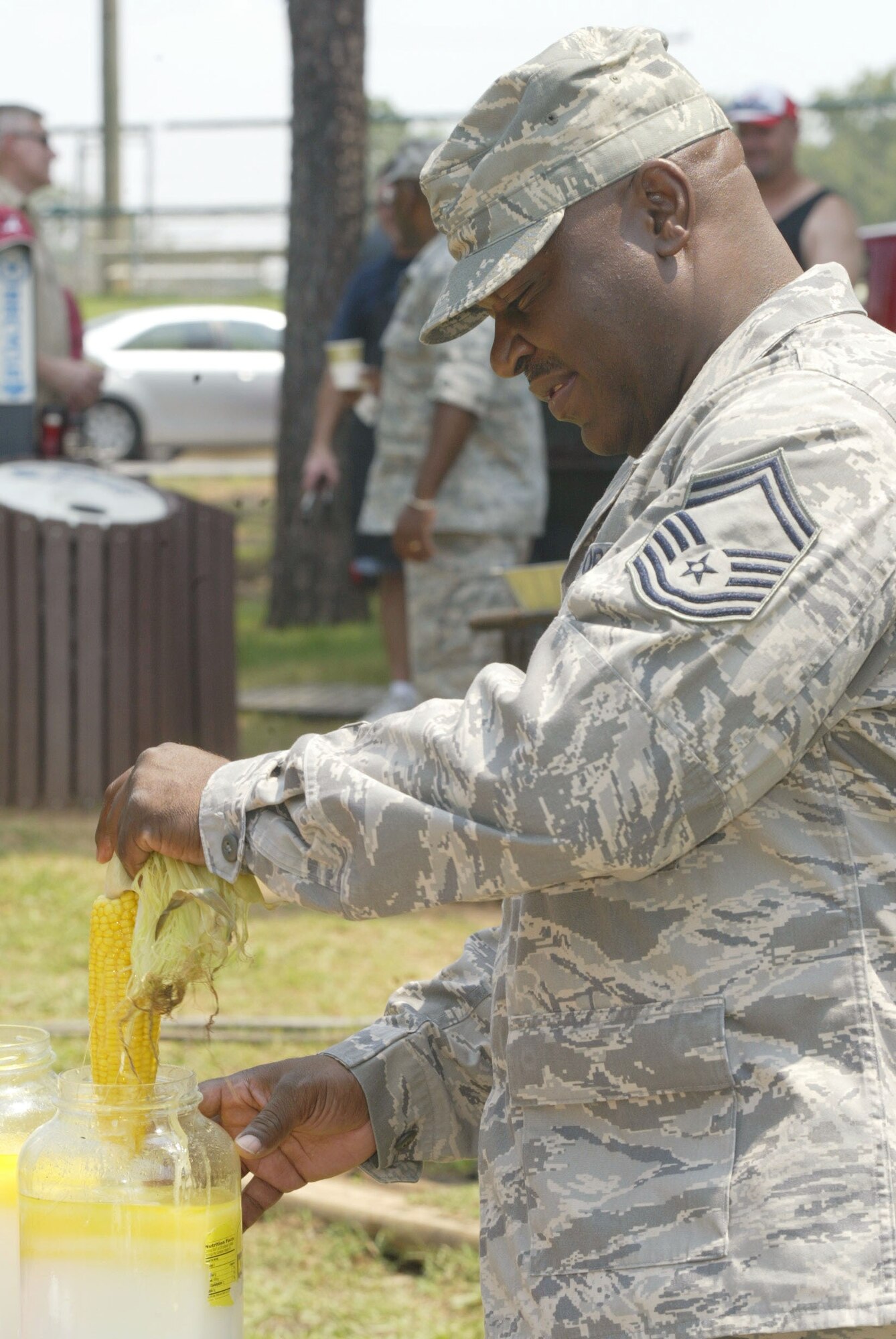 Senior Master Sgt. Daniel Simmons from the 22nd Air Force prepares to enjoy a grilled ear of corn at the annual Corn n' Sausage Roast held at the Lakeside Pavilion at Dobbins ARB July 16. The annual event, coordinated by Ron Durant of the 94th Safety office, serves as a fund raiser for Dobbins families. Besides chowing down on corn and sausage, attendees can bid on items such as hand-made quilts and birdfeeders. Last year, more than $2,100 was raised.