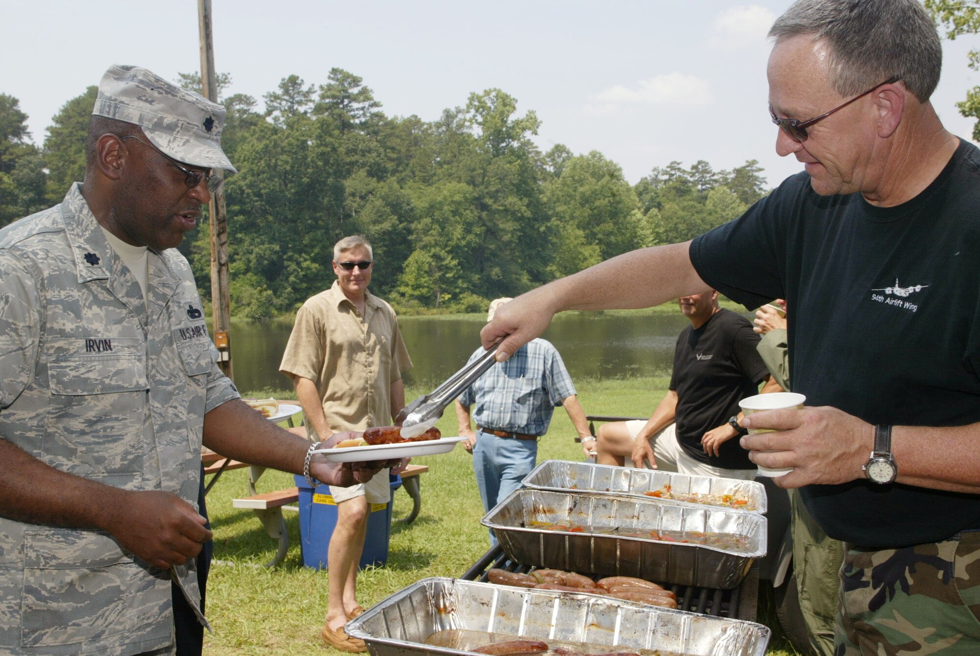 Lt. Col. Marshall Irvin, 94th Mission Support Group, grabs some grub at the annual Corn n' Sausage Roast held at the Lakeside Pavilion at Dobbins ARB July 16.  The annual event, coordinated by Ron Durant of the 94th Safety office, serves as a fund raiser for Dobbins families. Besides chowing down on corn and sausage, attendees can bid on items such as hand-made quilts and birdfeeders. Last year, more than $2,100 was raised.