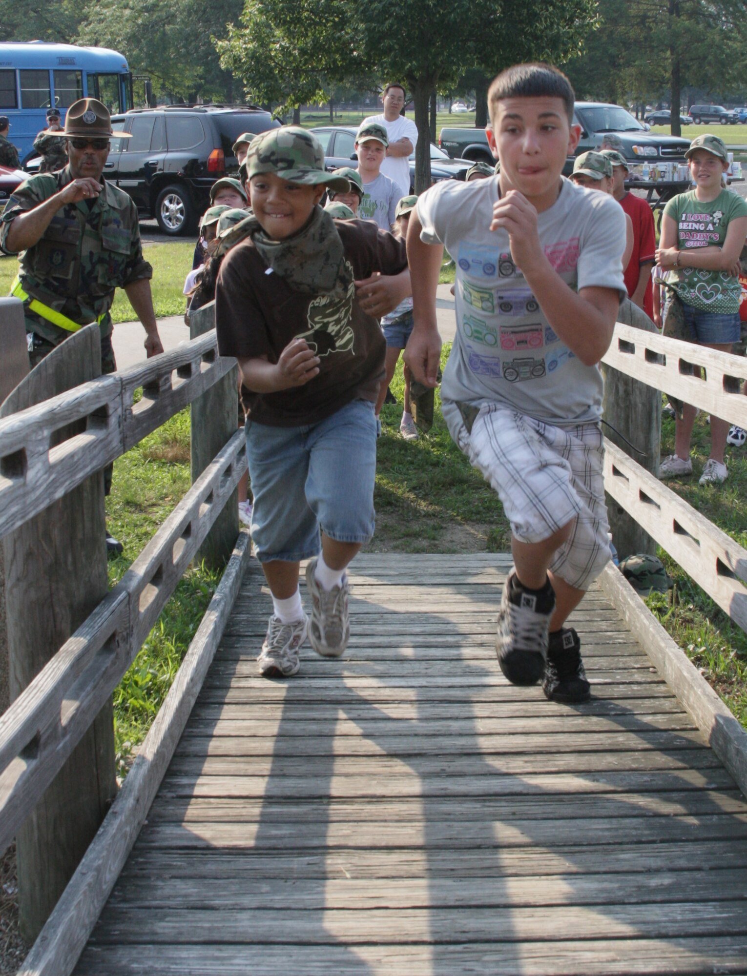MCGUIRE AFB, NJ - Aaron and Steve, both  children of military reservists with the 514th Maintenance Group run a challenge course during a "Mini-Boot Camp" while other unit members and families look on. This event was hosted by the 514 MXG as part of its annual family day held on July 12. (Air Force Photo/Master Sgt Mario Vasquez)