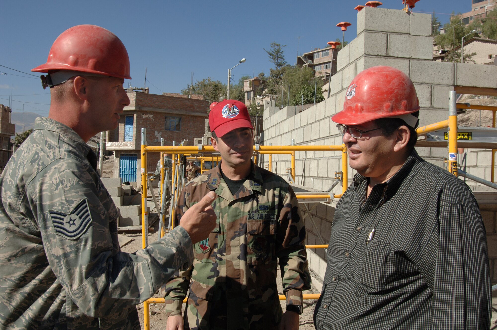 Tech. Sgt. Chris Belknap, project manager, describes the construction progress of a clinic 820th RED HORSE Squadron engineers are building in San Cristobal, Peru, July 13, to Dr. Luis Cabeña, Chief of Staff to the Peruvian Ministry of Defense.  The engineers are part of a task force supporting New Horizons - Peru 2008, a U.S. and Peruvian effort to bring quality-of-life improvements to the people of Peru. (U.S. Air Force Photo/1st Lt. Mary Pekas) 