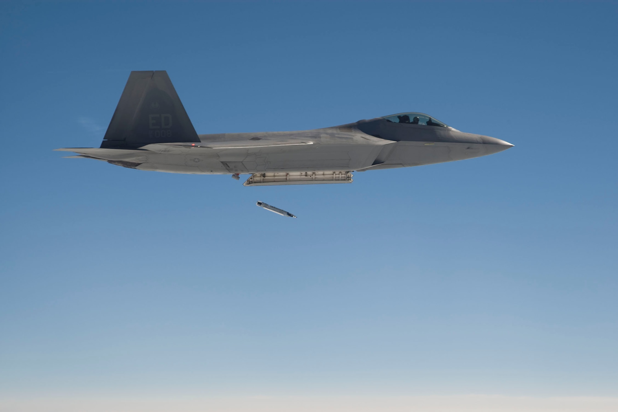 An Edwards F-22 Raptor drops a GBU-39 Small Diameter Bomb for the first time July 11 as part of a safe separation test to integrate the bomb to the aircraft. The SDB is a 250-pound class precision guided munition capable of destroying high-priority stationary targets from Air Force fighters and bombers from stand-off distances. 
(Lockheed-Martin photo by Kevin Robertson)
