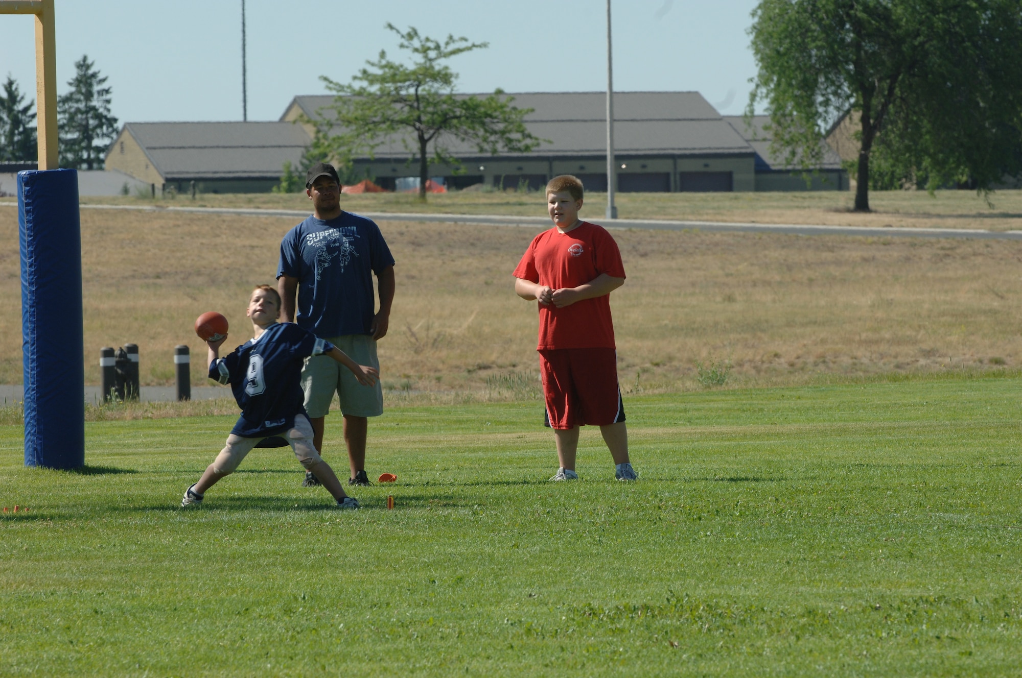 FAIRCHILD AIR FORCE BASE, Wash. -- Dylan Bruton, 10, son of Staff Sgt. Donald Bruton, 92nd Aircraft Maintenance Squadron, rears back for his pass during the NFL Punt, Pass and Kick competition hosted by the 92nd Services Squadron here July 11. (U.S. Air Force photo / Senior Airman Jocelyn Ford)
