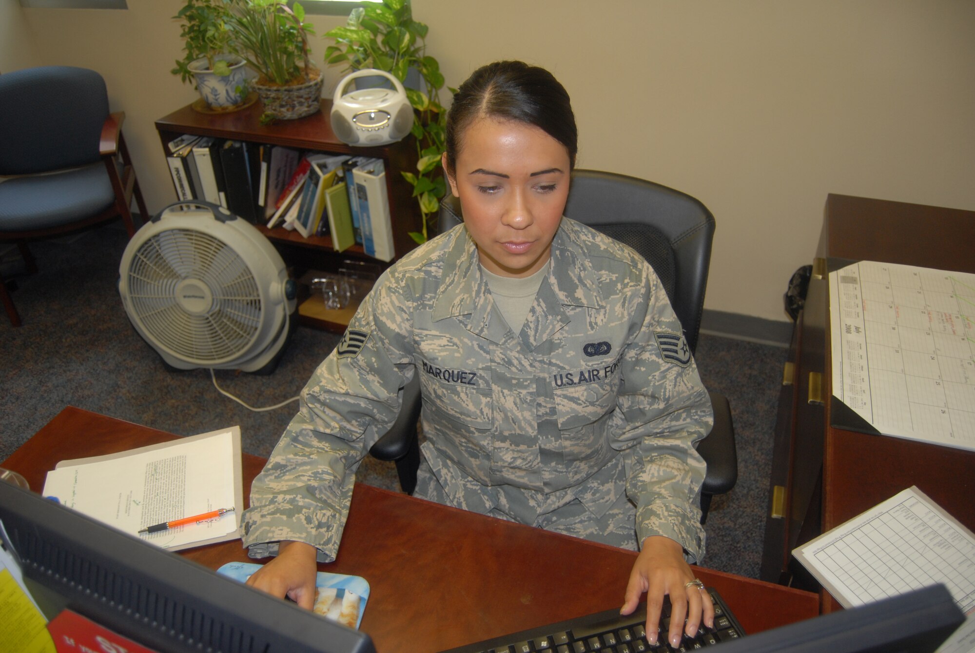 Staff Sgt. Adriana Marquez, 43rd Operations Support Squadron, reviews an award package July 11. Some of her job duties include reviewing awards and decorations, writing office reports and memos and keeping track of her commander’s calendar. (U.S. Air Force Photo by Airman 1st Class Mindy Bloem)