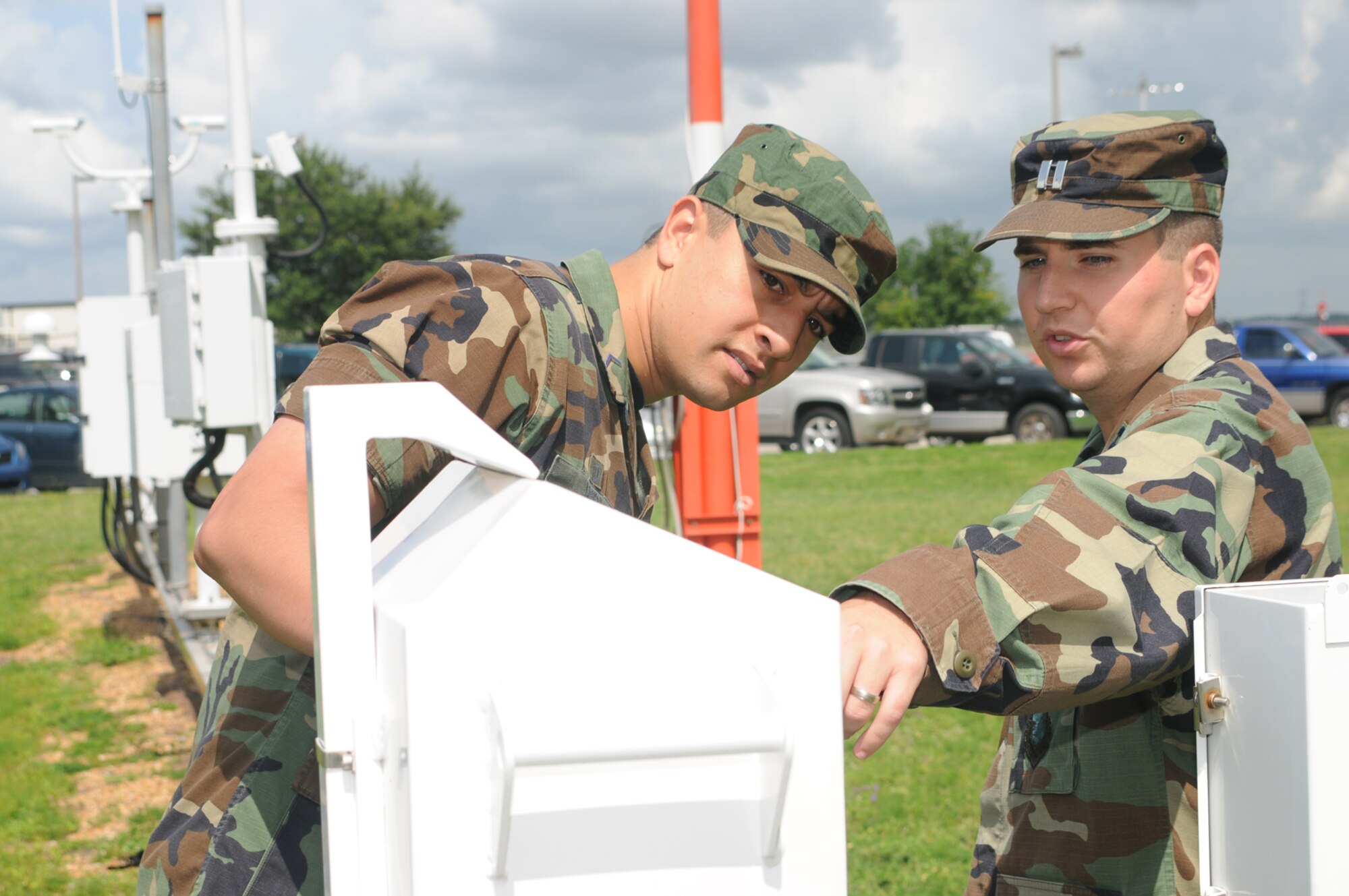 Cadet Fakhri Mokni, left, a foreign exchange student at the Air Force Academy, gets a tour of meteorological equipment outside the weather training facility from Capt. Brian Miller, 335th Training Squadron.  Cadet Mokni, a participant in the Third Lieu-tenant course, returns to the Tunisian Air Force for commissioning after he graduates from the academy.  (U.S. Air Force photo by Kemberly Groue)