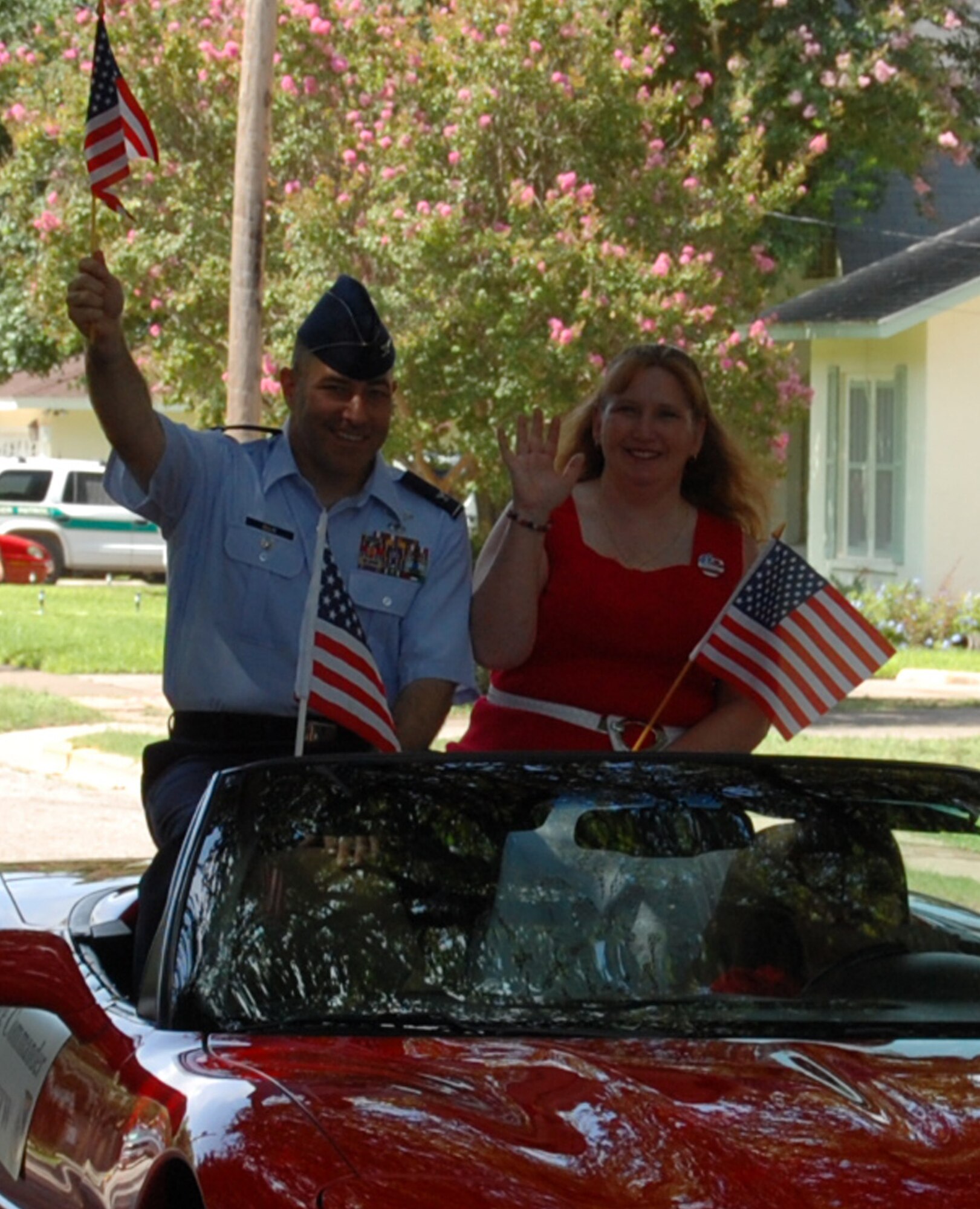 Col. Dave Ellis, 47th Flying Training Wing vice commander, and his wife, Erin, wave to Del Rio community members during a parade to honor the 4th of July. Colonel Ellis, commonly referred to as ‘Doc’ among his peers, is the new 47th FTW vice commander. (U.S. Air Force photo/1st Lt. Courtney Kippenberger)
