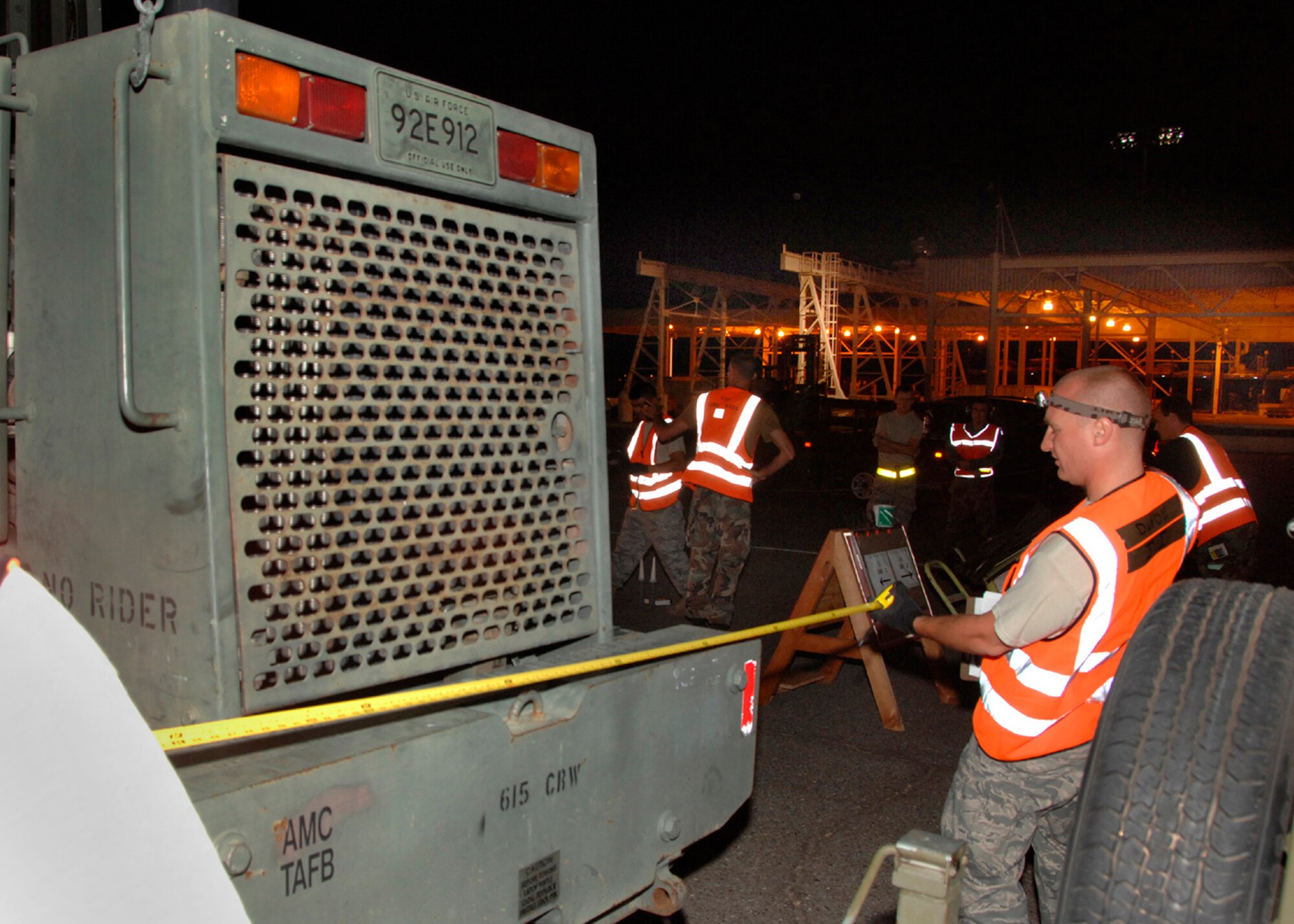 TRAVIS AIR FORCE BASE, Calif. -- Inspecting the details: Staff Sgt. Andreas Csepely, Joint Inspector for the 45th Aerial Port Squadron, checks final measurements July 13, on an all-terrain forklift to be loaded on a Team Travis aircraft deploying in Hydra Exercise ’08. Sergeant Csepely is part of a team that inspects and weighs cargo to make sure equipment and supplies are properly prepared to be transported by air.  During the 615th Contingency Response Wing’s seven-day exercise, more than 1,000 Airmen, soldiers, and Marines will build up bare bases at five central California airfields and train to rapidly respond to a humanitarian disaster. (U.S. Air Force photo / Master Sgt. Wendy Weidenhamer) 