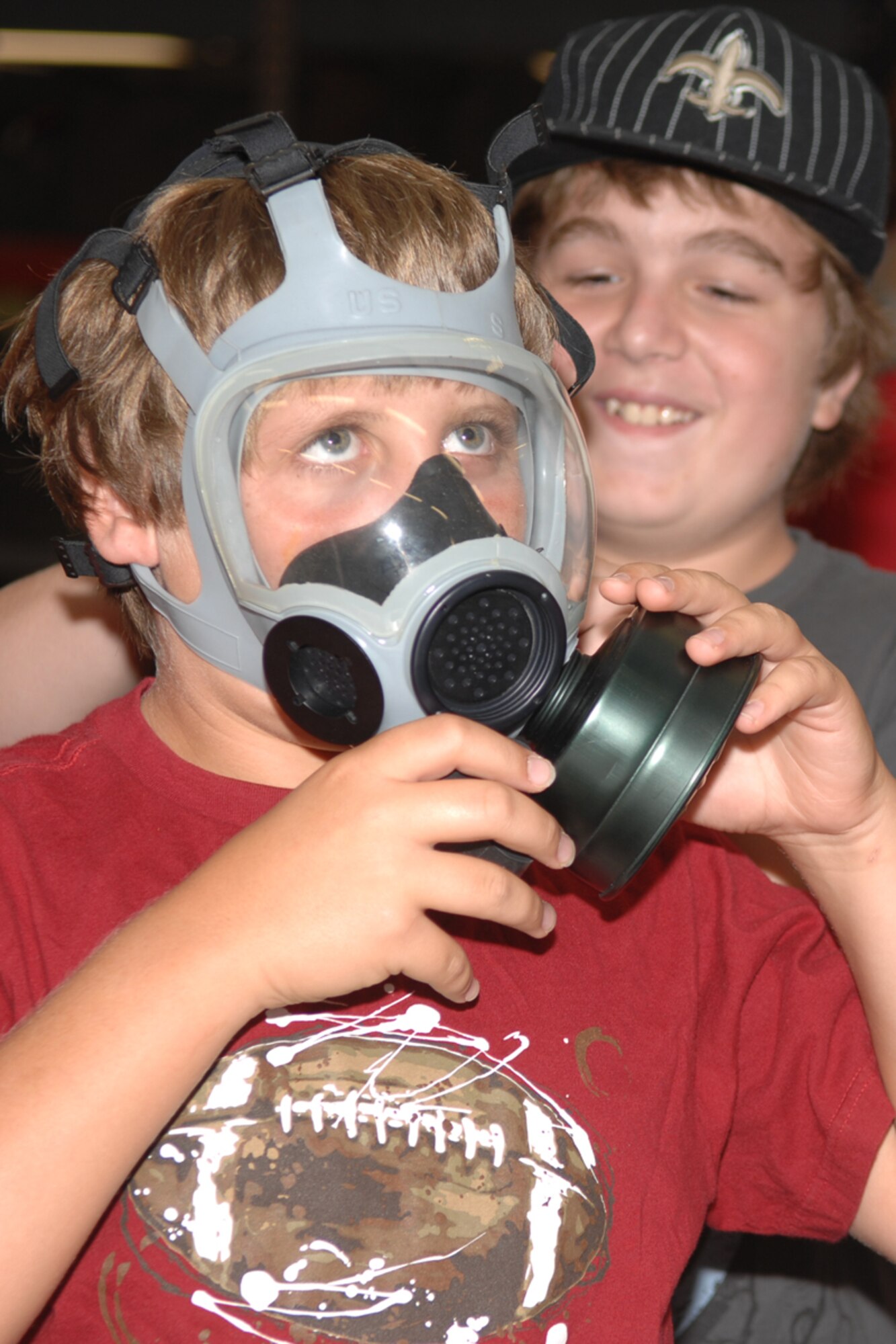 Joseph Dunn tries on a gas mask at the Hurlburt Field Deployment Control Center during the Air Force Adventure Camp July 16. The camp allows military children to see some of the deployment processes their parents experience. (U.S. Air Force photo/Airman 1st Class Kimberly Darnall)
