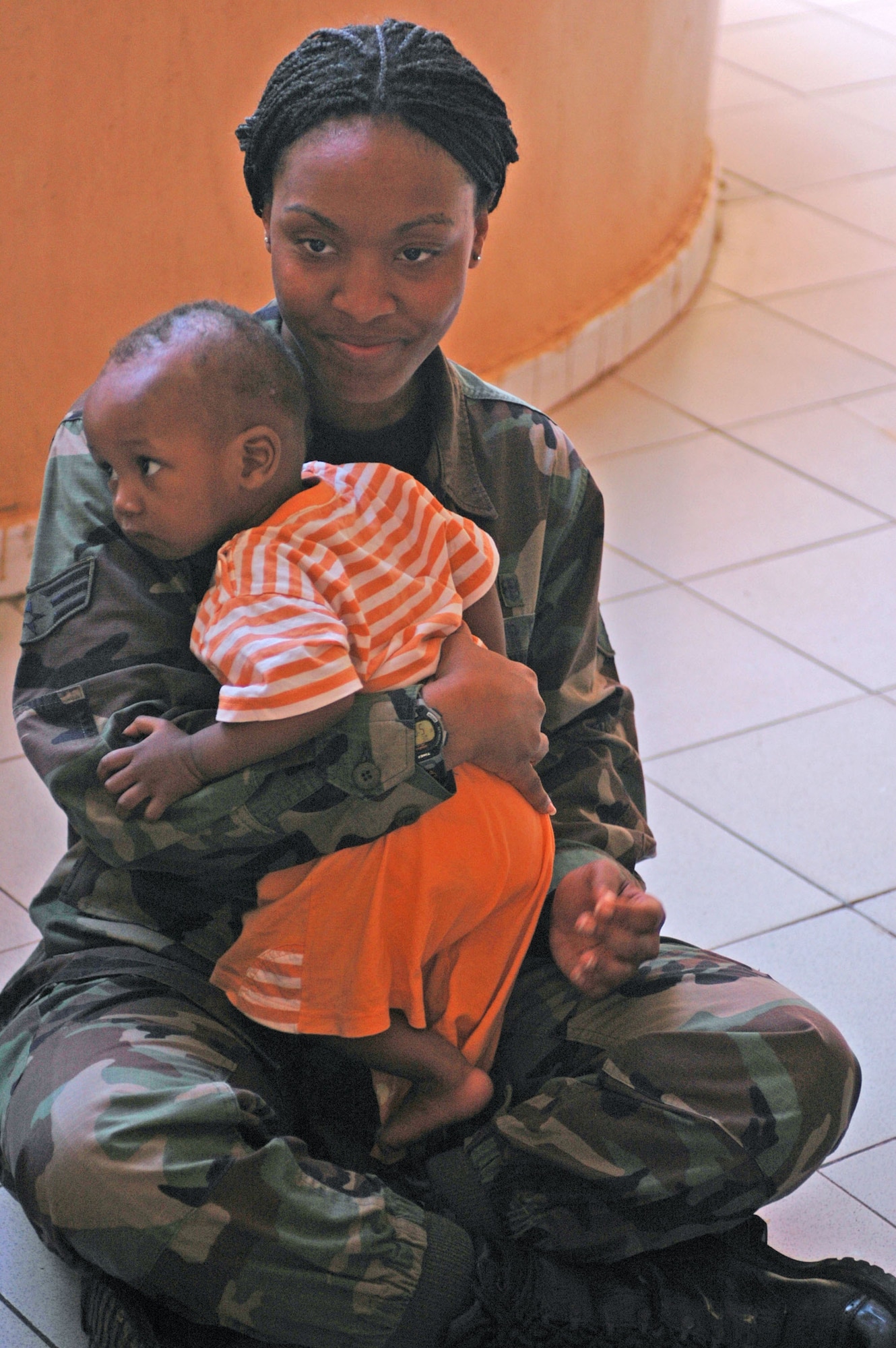 BAMAKO, Mali -- Senior Airman Latrisha Peebles holds a Malian baby July 16, 2008, at a local orphanage in Bamako. Airman Peebles is one of more than 90 servicemembers deployed to Bamako for MEDFLAG 08, a multi-national medical training exercise designed to enhance medical capabilities and readiness for U.S. and African forces. She is assigned to the 31st Medical Group, Aviano Air Base, Italy. (U.S. Air Force photo/Senior Airman Justin Weaver)