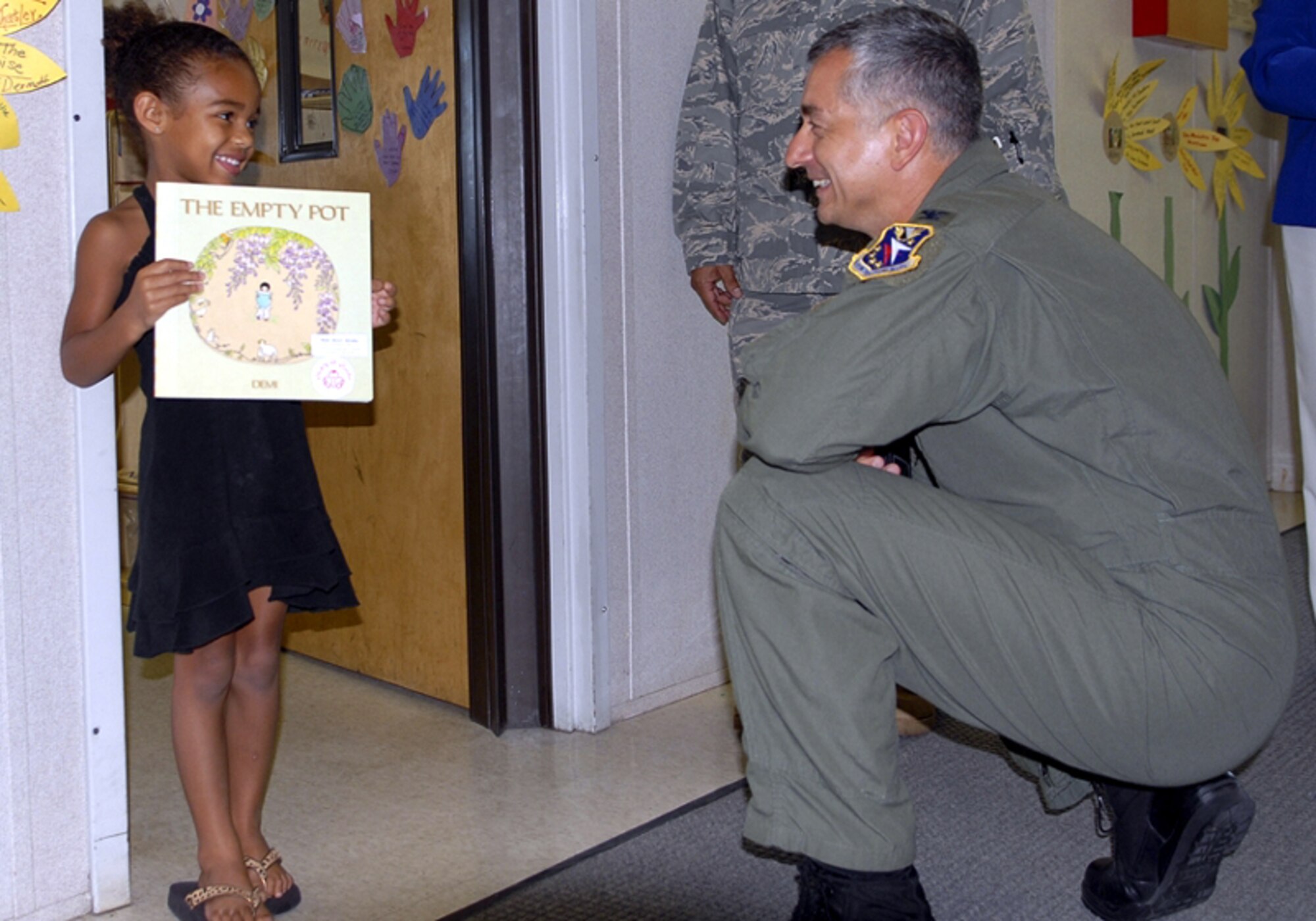 Colonel Roger Watkins, 14th Flying Training Wing commander, interacts with a child at the Columbus AFB Child Development Center during his immersion of the 14th Mission Support Group. (U.S. Air Force photo by Elizabeth Owens)