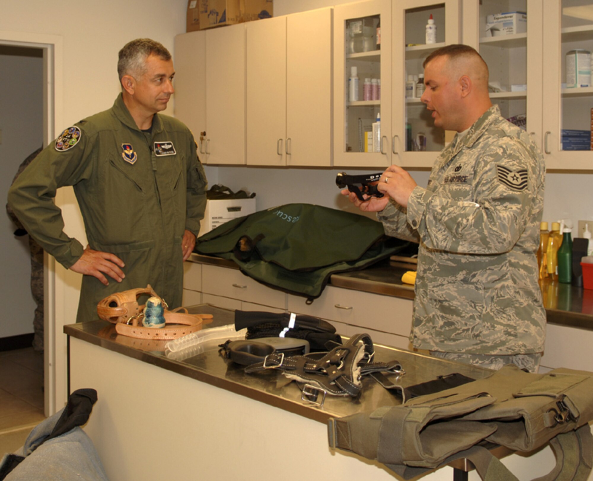 Technical Sgt. Christopher Barnett, 14th Security Forces Squadron, gives Col. Roger Watkins, 14th Flying Training Wing commander, a tour of the Columbus AFB dog kennel during his immersion of the 14th Mission Support Group. (U.S. Air Force photo Elizabeth Owens)