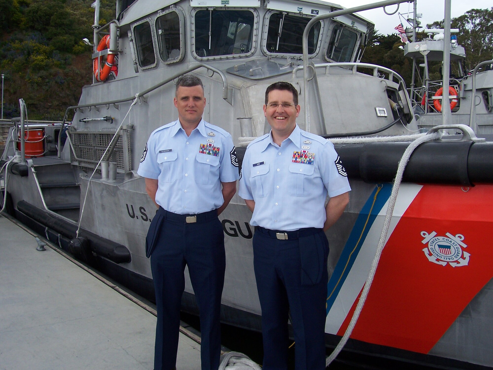 Master Sgts Chance Glascock and Christopher King stand in front of a Coast Guard boat in Petaluma, Calif. Both Aviano Air Base, Italy, first sergeants recently had the opportunity to attend the U.S. Coast Guard Chief Petty Officer Academy. The advanced training is offered to only 40 Air Force senior NCOs a year. (U.S. Air Force photo)
