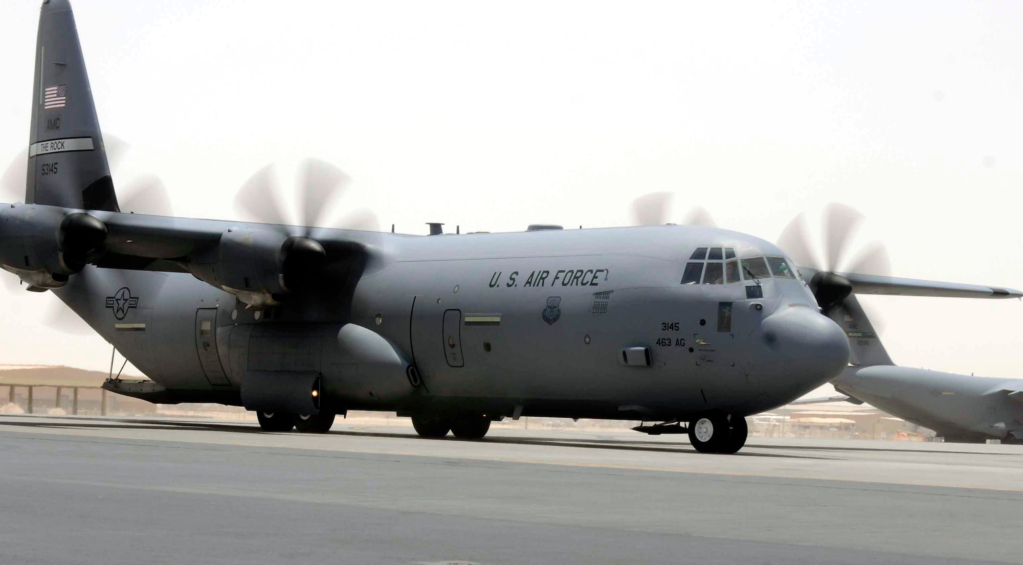 A C-130 Hercules taxis to a loading zone July 8 in Southwest Asia. The C-130 can accommodate a wide variety of oversized cargo, including everything from utility helicopters and six-wheeled armored vehicles to standard palletized cargo and military personnel. In an aerial delivery role, it can airdrop loads up to 42,000 pounds or use its high-flotation landing gear to land and deliver cargo on rough, dirt strips. (U.S Air Force photo/Senior Airman Domonique Simmons) 