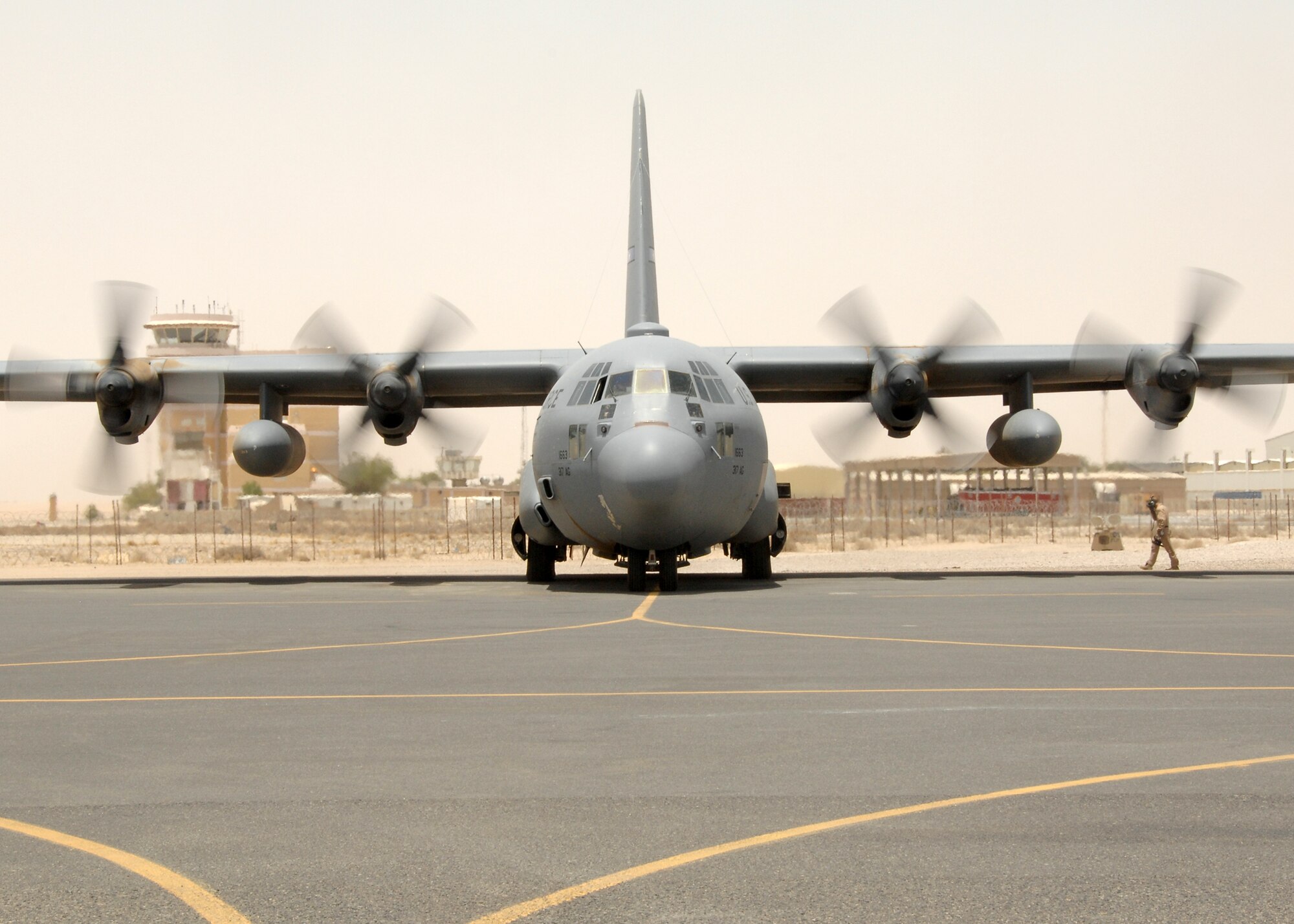 SOUTHWEST ASIA -- A C-130 Hercules, deployed to the 386th Air Expeditionary Wing, powers up the engines and prepares to depart the parking ramp on July 17 at a base in Southwest Asia. The aircraft is deployed from the 317th Airlift Group, Dyess Air Force Base, Texas. (U.S. Air Force photo/Tech. Sgt. Raheem Moore)