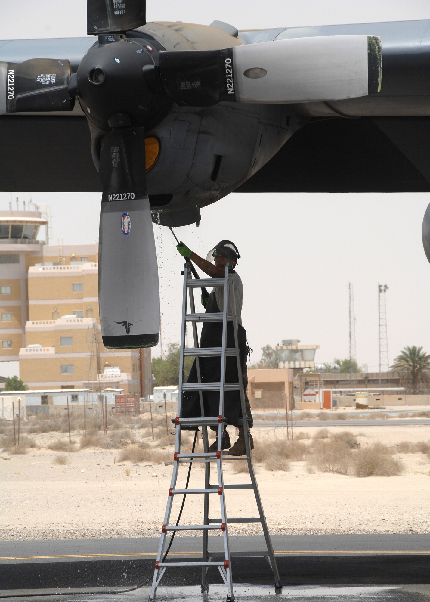 SOUTHWEST ASIA -- Airman 1st Class Ivan Chavez, a crew chief assigned to the 386th Expeditionary Aircraft Maintenance Squadron, pressure washes an engine oil cooler on July 17 at a base in Southwest Asia. Airman Chavez is deployed from the 317th Airlift Group, Dyess Air Force Base, Texas. (U.S. Air Force photo/Tech. Sgt. Raheem Moore)