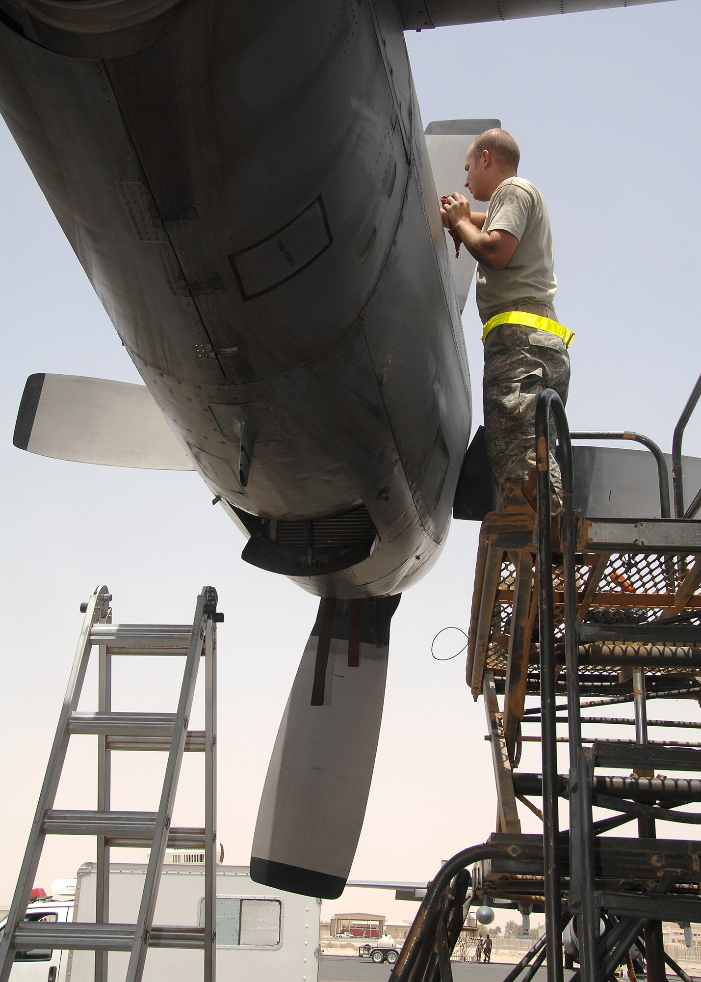SOUTHWEST ASIA -- Senior Airman Anthony Boyd, a crew chief assigned to the 386th Expeditionary Aircraft Maintenance Squadron, checks the engine of a C-130 Hercules for a suspected oil leak on July 17 at a base in Southwest Asia. Airman Boyd is deployed from the 317th Airlift Group, Dyess Air Force Base, Texas. (U.S. Air Force photo/Tech. Sgt. Raheem Moore)