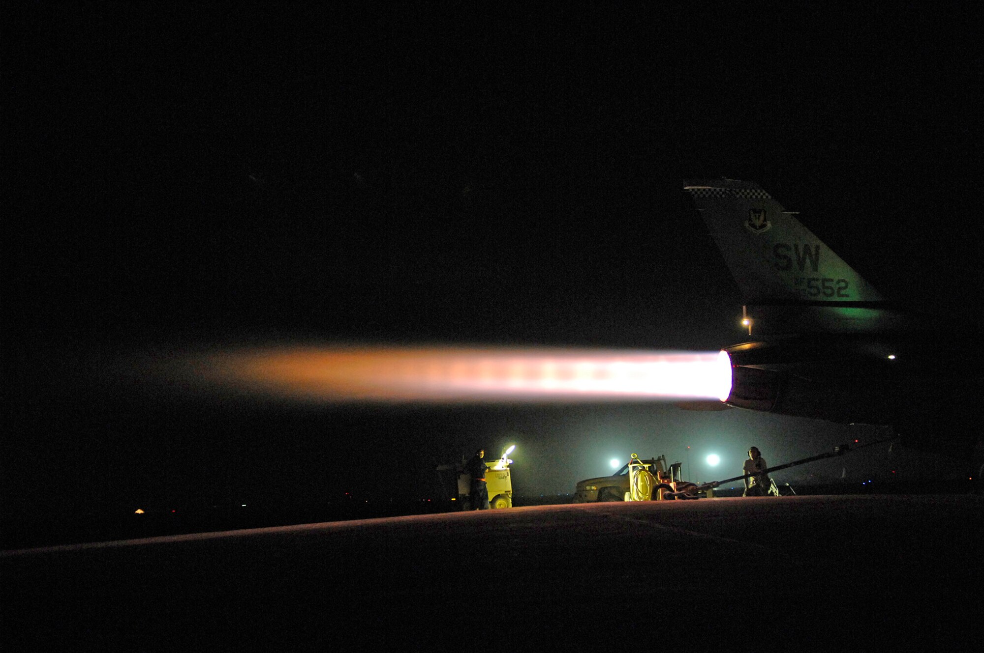 JOINT BASE BALAD, Iraq -- Senior Airman Graham Willis and Staff Sgt. Michael Danigel, 77th Aircraft Maintenance Unit engine mechanics, communicate back and forth from the cockpit to ground, comparing the readings of cockpit computers with the physical responses of an F-16 Fighting Falcon engine here July 16. Airman Willis and Sergeant Danigel are both deployed from Shaw Air Force Base, S.C. (U.S. Air Force photo/Senior Airman Julianne Showalter)