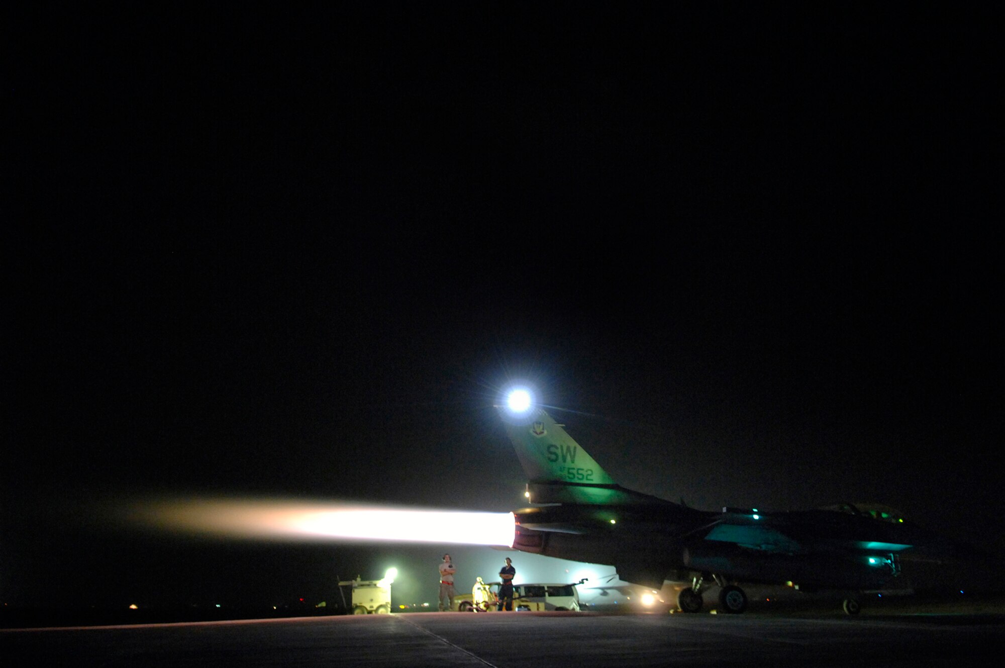 JOINT BASE BALAD, Iraq -- Senior Airman Graham Willis and Staff Sgt. Ferdinand Brown, 77th Aircraft Maintenance Unit engine mechanics, observe an engine run up of an F-16 Fighting Falcon here, July 16. During the run up, the mechanics stay vigilant for faulty parts and, after the run up, will fix them on the spot. Going back and forth from full afterburner to idle puts stress and varying power levels through the jet and tests the computer in the cockpit with the jet's physical responses. Airman Willis and Sergeant Brown are both deployed from Shaw Air Force Base, S.C. (U.S. Air Force photo/Senior Airman Julianne Showalter)