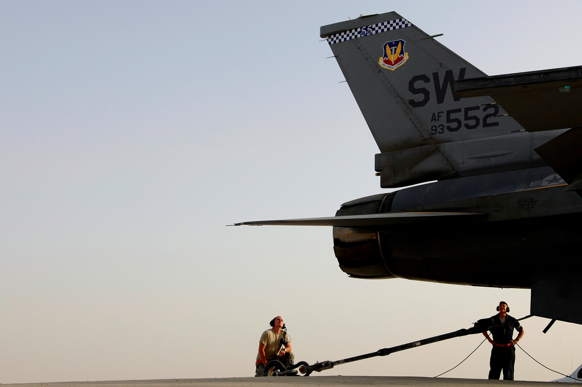 JOINT BASE BALAD, Iraq -- Senior Airman Graham Willis and Staff Sgt. Ferdinand Brown, 77th Aircraft Maintenance Unit engine mechanics, watch as an F-16 Fighting Falcon idles before going into full afterburner during an engine run up here July 16. The mechanics on the ground examine the engine during the run up checking for leaks, smoke, or anything else that may fail, while the mechanic in the cockpit goes through a checklist of gauges and components. Airman Willis and Sergeant Brown are both deployed from Shaw Air Force Base, S.C. (U.S. Air Force photo/Senior Airman Julianne Showalter)