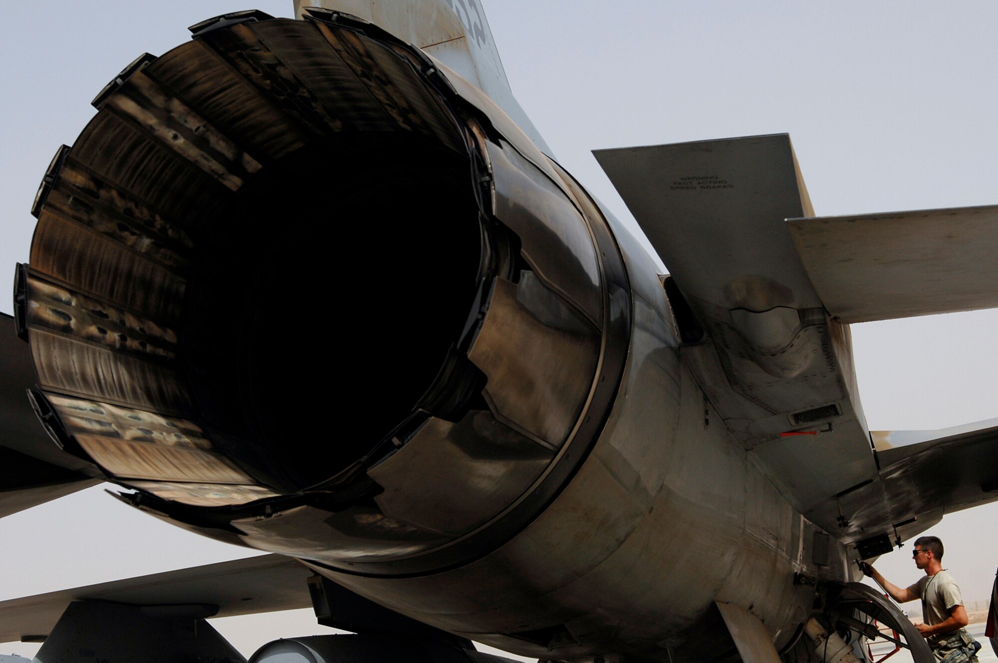 JOINT BASE BALAD, Iraq -- Senior Airman Sean Weygandt, a 77th Aircraft Maintenance Unit engine mechanic, screws in a panel on an F-16 Fighting Falcon before running up the engine here July 16. The run up of the engine back and forth from full afterburner to idle allows the engine mechanics and crew chiefs to ensure all systems are fully functional before putting the fighter back into operational use. Airman Weygandt is deployed from Shaw Air Force Base, S.C. (U.S. Air Force photo/Senior Airman Julianne Showalter)