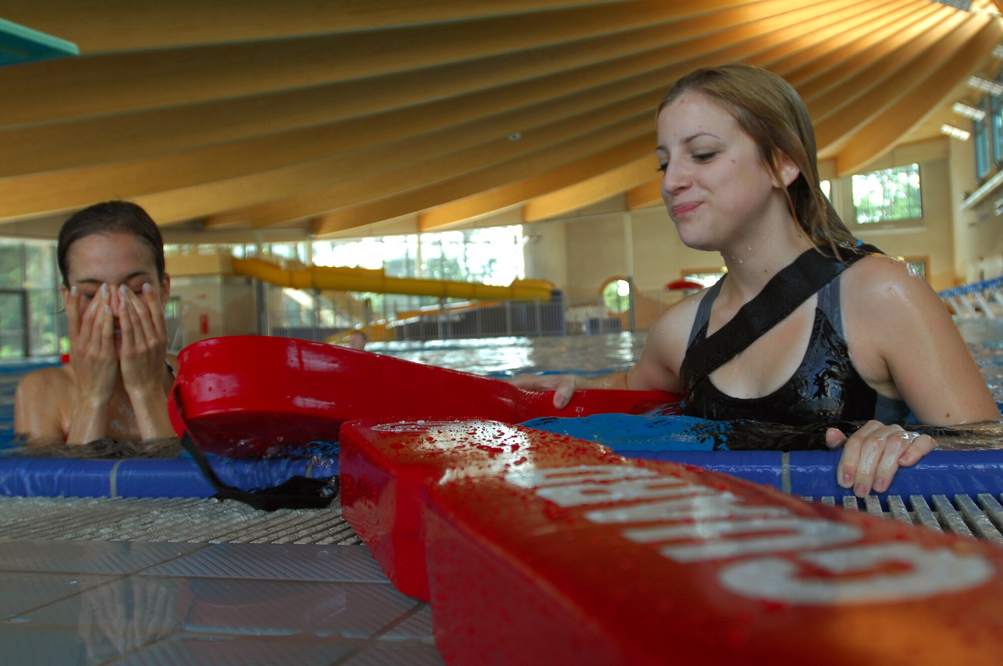 Mary McKinnon, left, daughter of U.S. Air Force Lt. Col. Martin McKinnon, U.S. Air Forces in Europe, 3rd Air Force, and Portia Scovern, daughter of U.S. Air Force Master Sgt. Brian Scovern, 1st Combat Communications Squadron, participates in life guard training at the new aquatic center on Ramstein Air Base, Germany, July 10, 2008. Several teenagers and adults participated in the training in anticipation of the opening of the new facility. (U.S. Air Force photo by Airman 1st Class Kenny Holston)(Released)