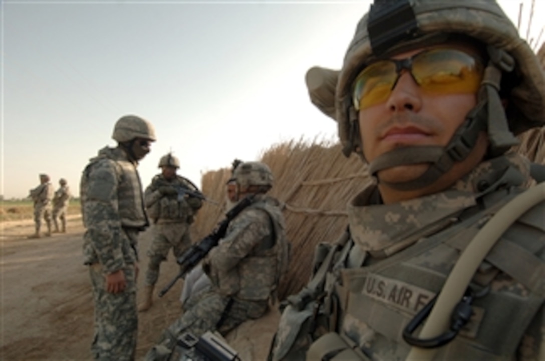 U.S. Air Force Staff Sgt. Jose Contreras, assigned to 1st Combat Camera Squadron, takes a break from documenting U.S. Army soldiers as they guard a checkpoint on a road in Al Sadr Yusifiyah, Iraq, on July 12, 2008.  