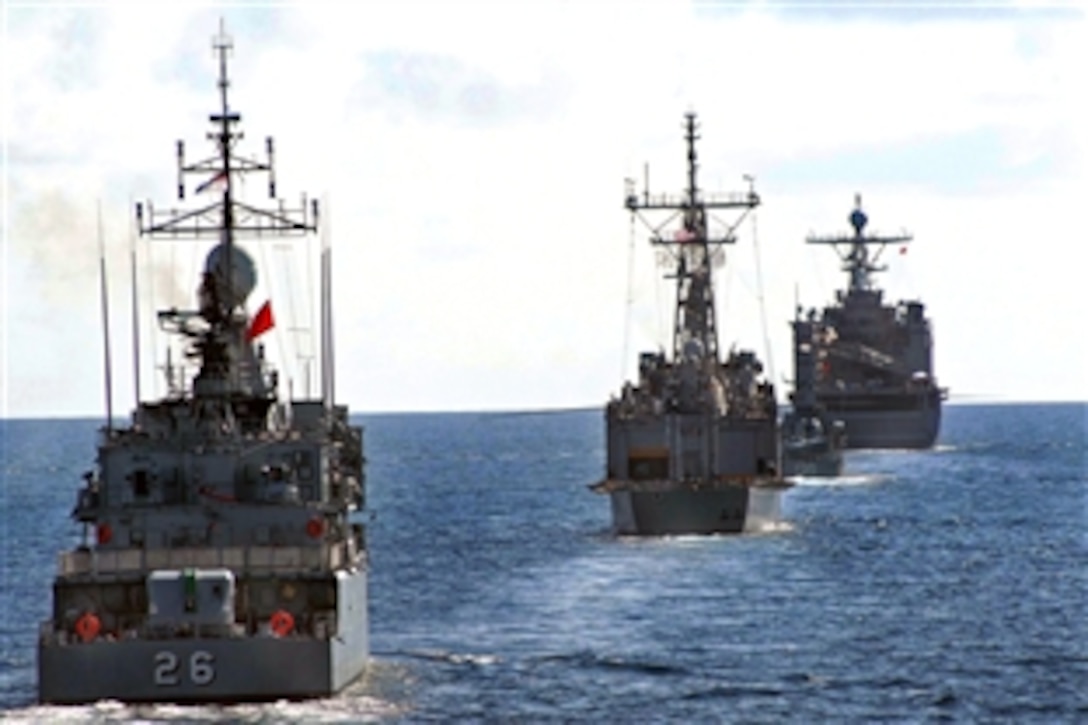The amphibious dock landing ship USS Tortuga 46 leads the way as the guided-missile frigate USS Jarrett 33, and the Royal Malaysian Navy ships KD Laksamana Tun Abdul Jamil F 135 and KD Lekir F 26, line up during a maneuvering exercise as part of the Malaysian phase of cooperation afloat readiness and training, CARAT 2008, South China Sea, July 14, 2008. CARAT is an annual series of bilateral maritime training exercises.