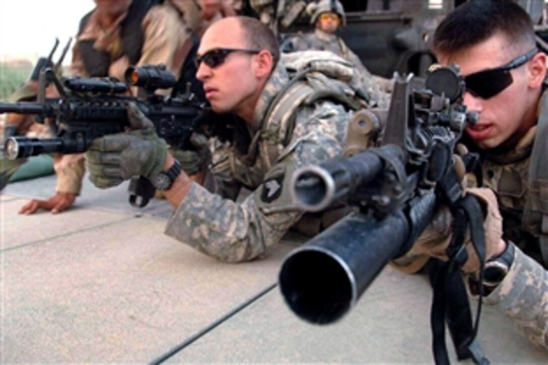 U.S. Army soldiers practice exiting from a Black Hawk helicopter and taking a fighting position before their air assault mission in Sadr Yusifiyah, Iraq, July 13, 2008. The soldiers are assigned to the 101st Airborne Division's 1st Battalion, 187th Infantry Regiment. 

