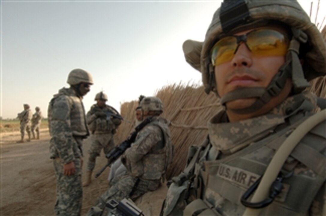 U.S. Air Force Staff Sgt. Jose Contreras, assigned to 1st Combat Camera Squadron, takes a break from documenting U.S. Army soldiers as they guard a checkpoint on a road in Al Sadr Yusifiyah, Iraq, on July 12, 2008.  