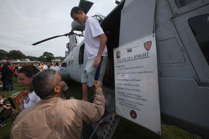 Students tour a CH-46 Sea Knight helicopter at Massapequa High School during a helicopter raid demonstration performed by the Marines of Special Purpose Marine Air Ground Task Force New York May 29.  More than 3,000 Marines, Sailors and Coast Guardsmen will be in the area participating in community outreach events and equipment demonstrations. This is the 26th year New York City has hosted the sea services for Fleet Week.